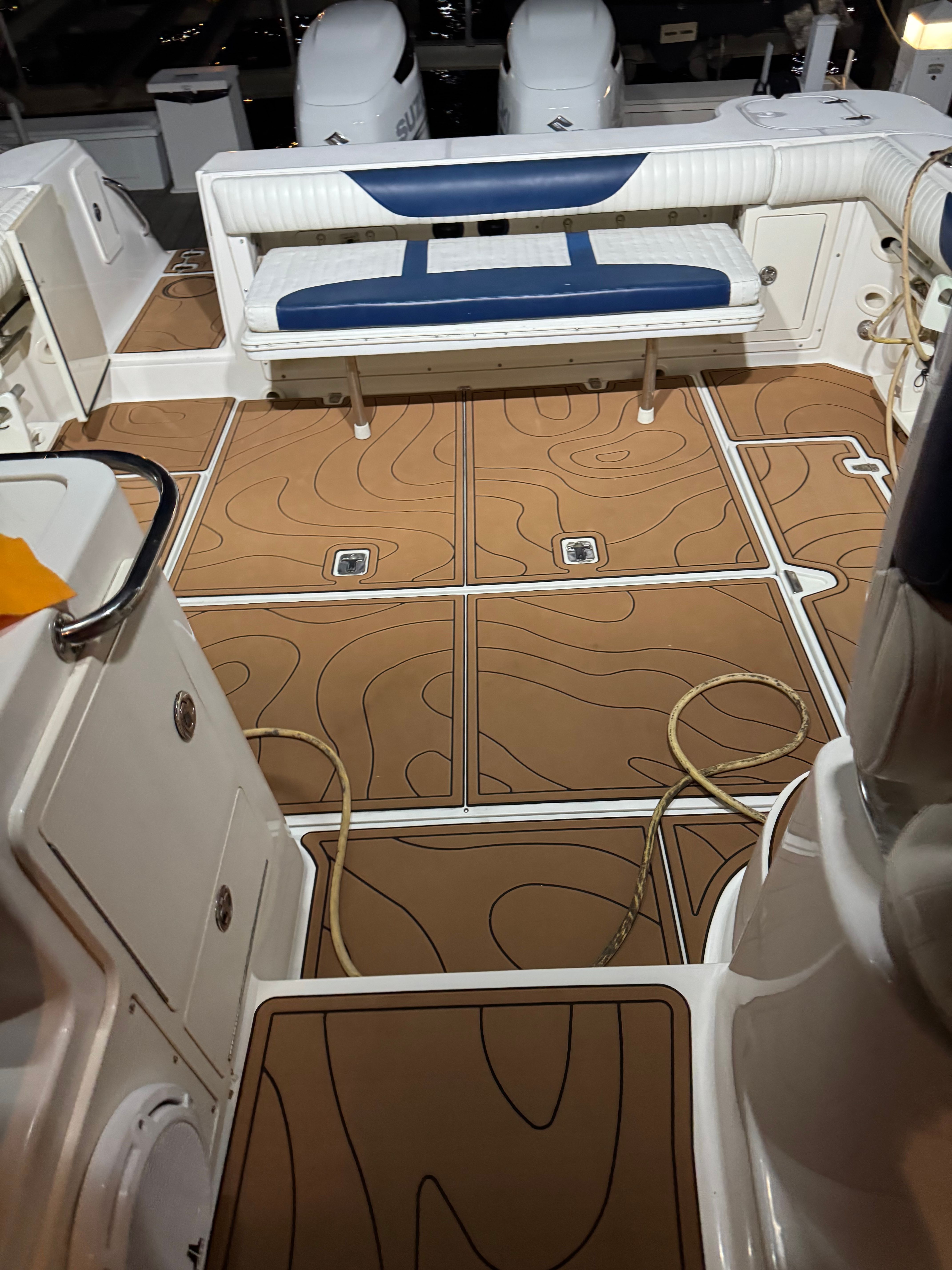 Interior of a 2005 Boston Whaler 305 Conquest boat with seating bench.
