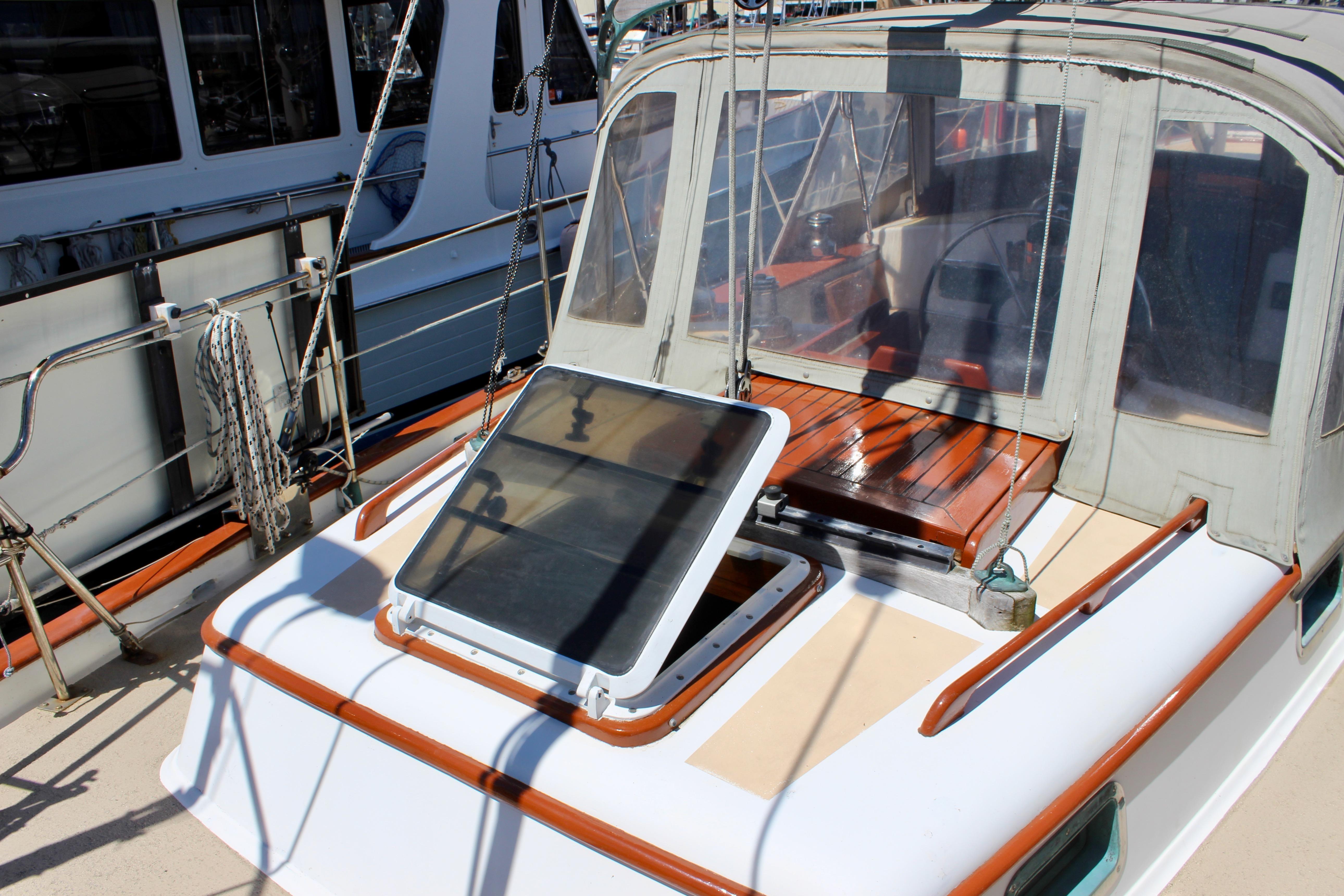 1981 Kelly Peterson 46 sailboat cockpit with open hatch and wooden seating.
