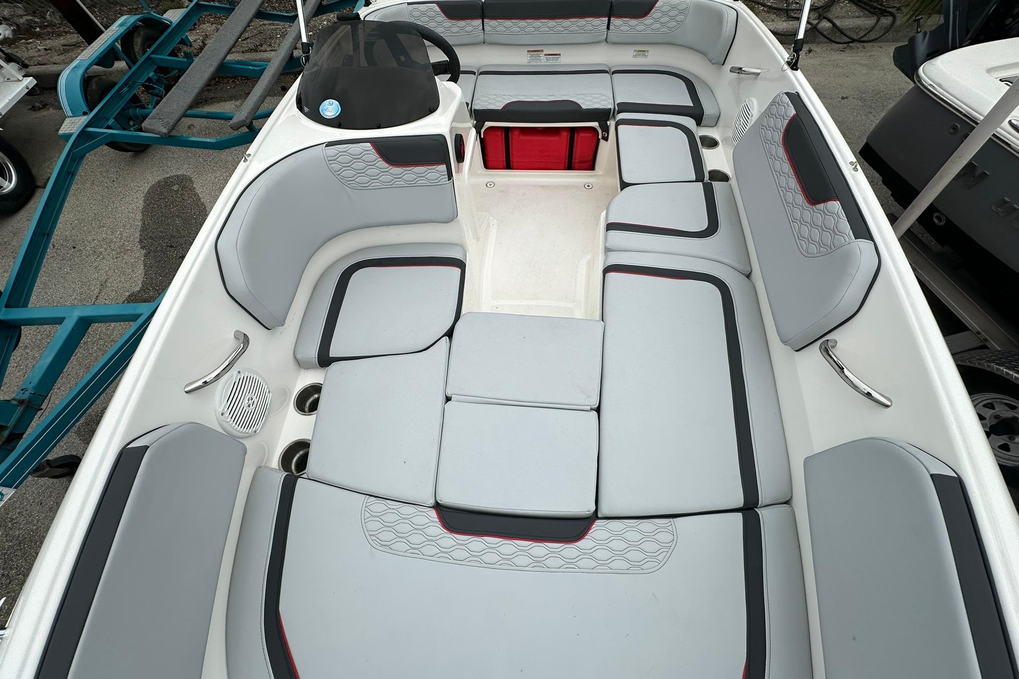 2024 Bayliner Element M15 boat interior with gray seating and red accents.