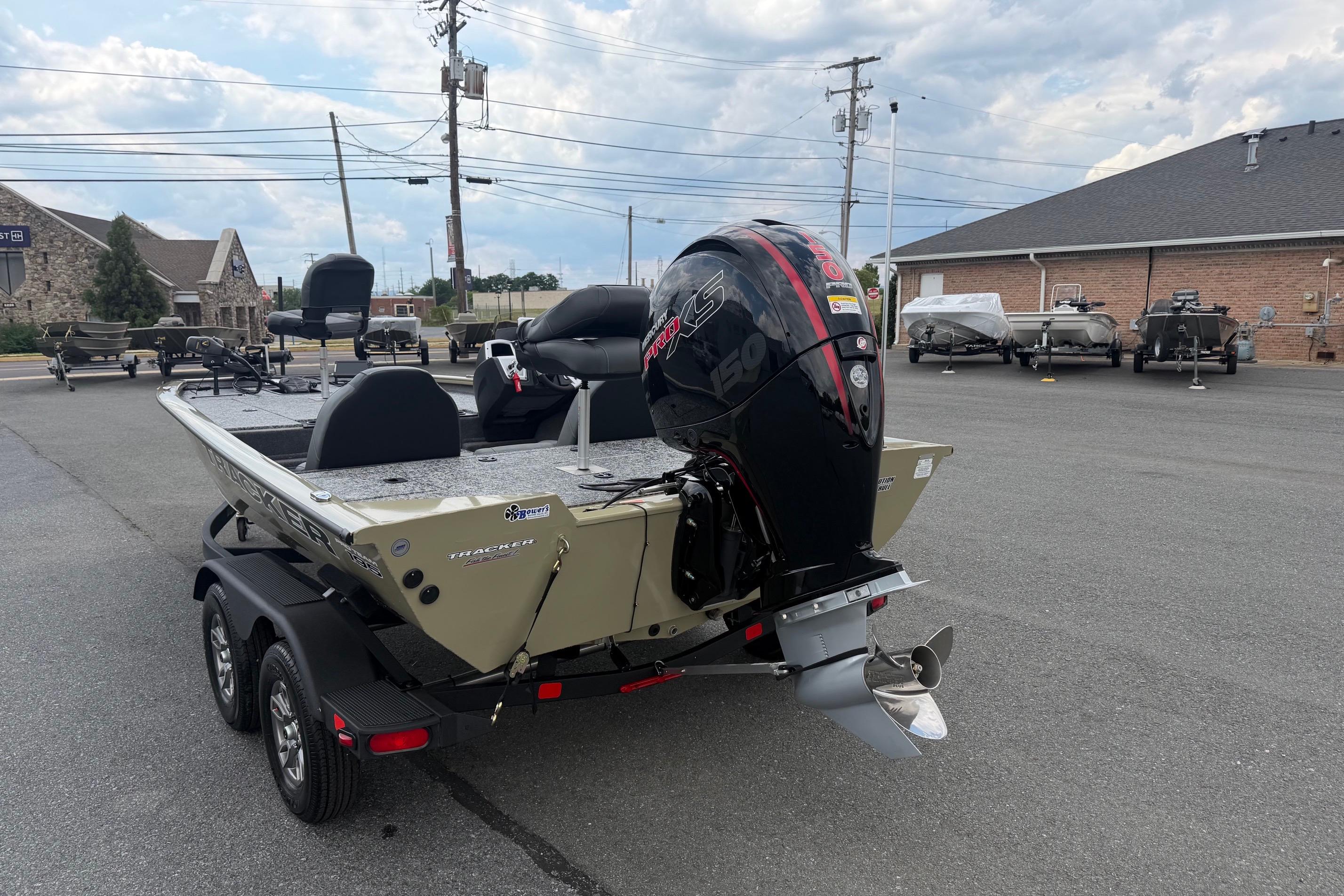 2026 Tracker Pro Team 195 boat with powerful outboard motor in a dealership lot.