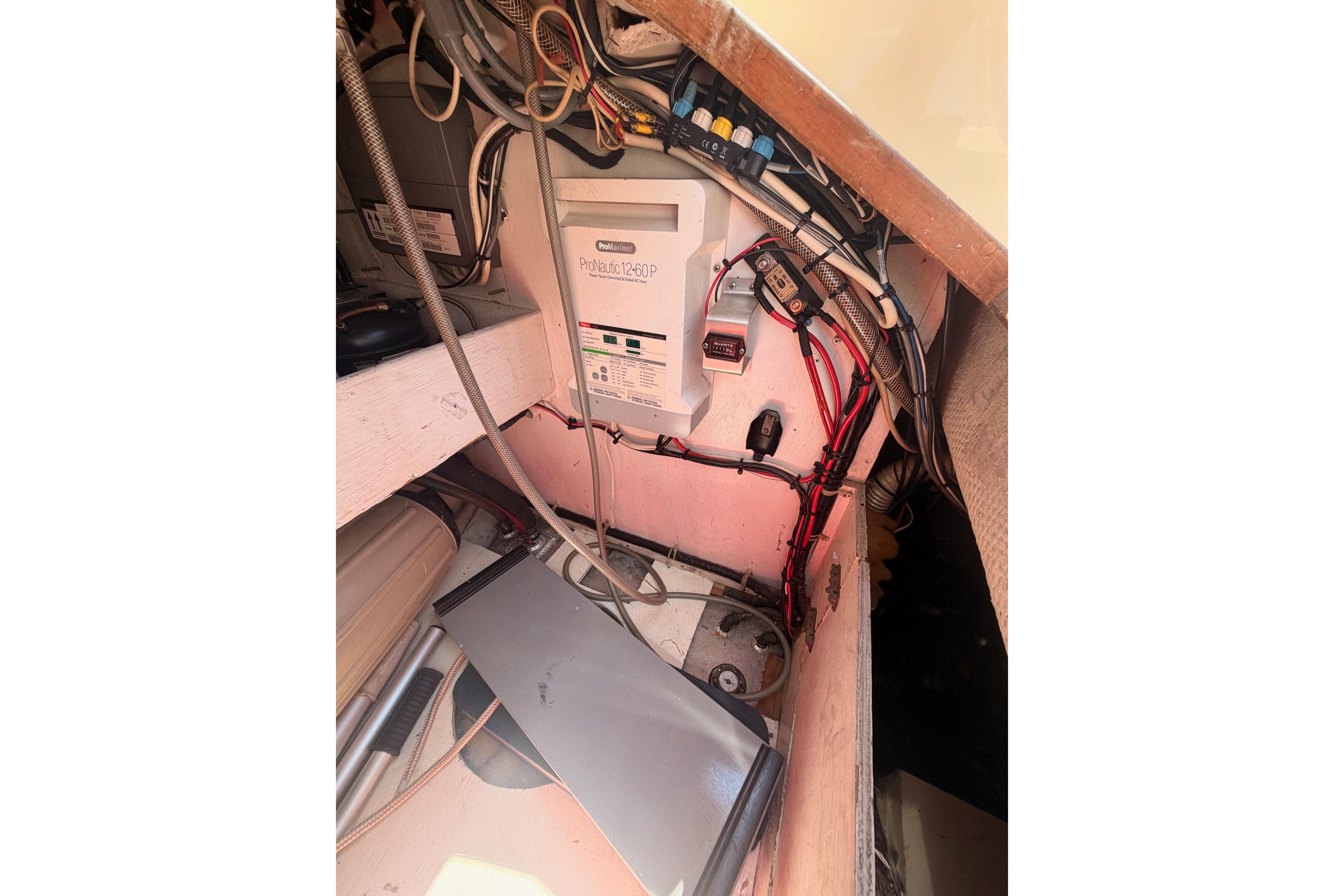Electrical setup inside a 1991 Caliber 33 boat, featuring wiring and a ProNautic charger.