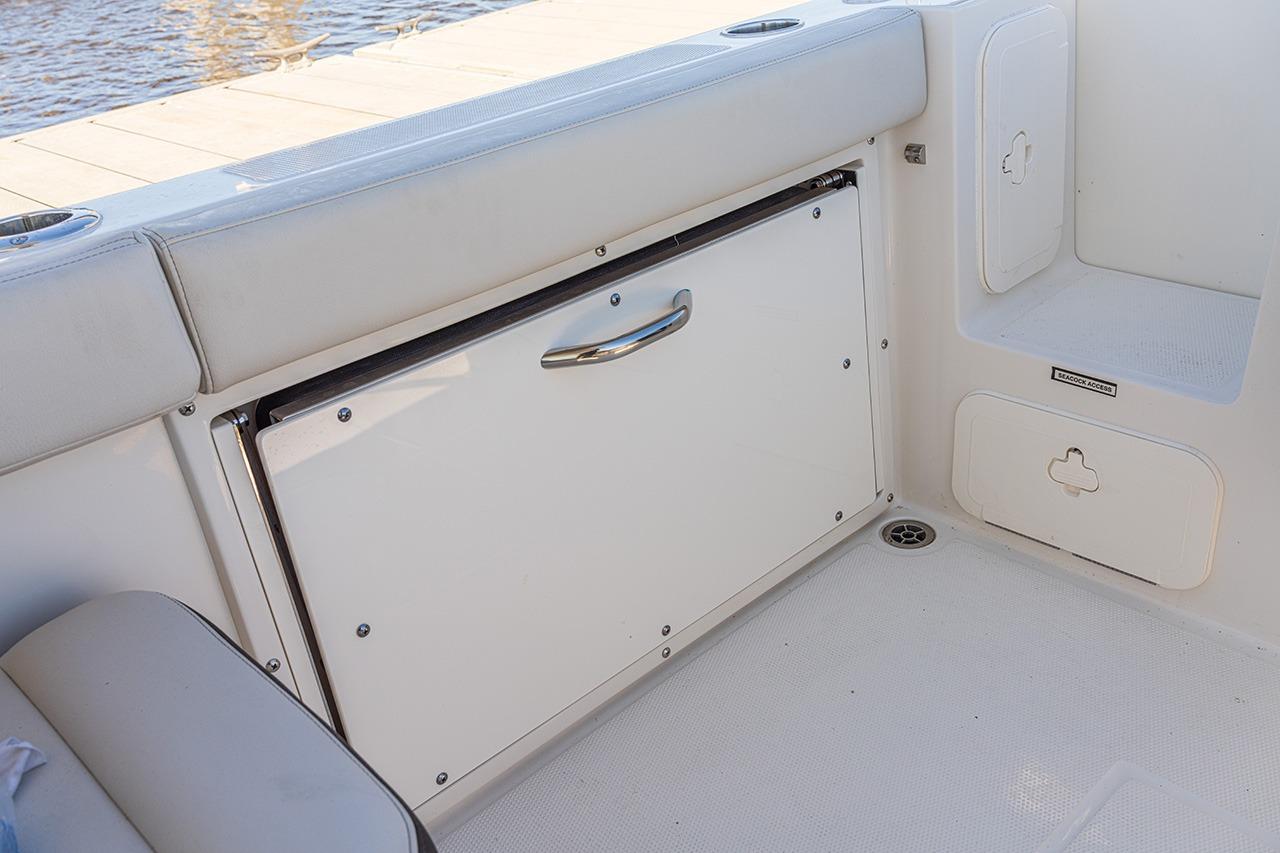 2026 Sailfish 245 DC boat interior with storage compartments and seating.