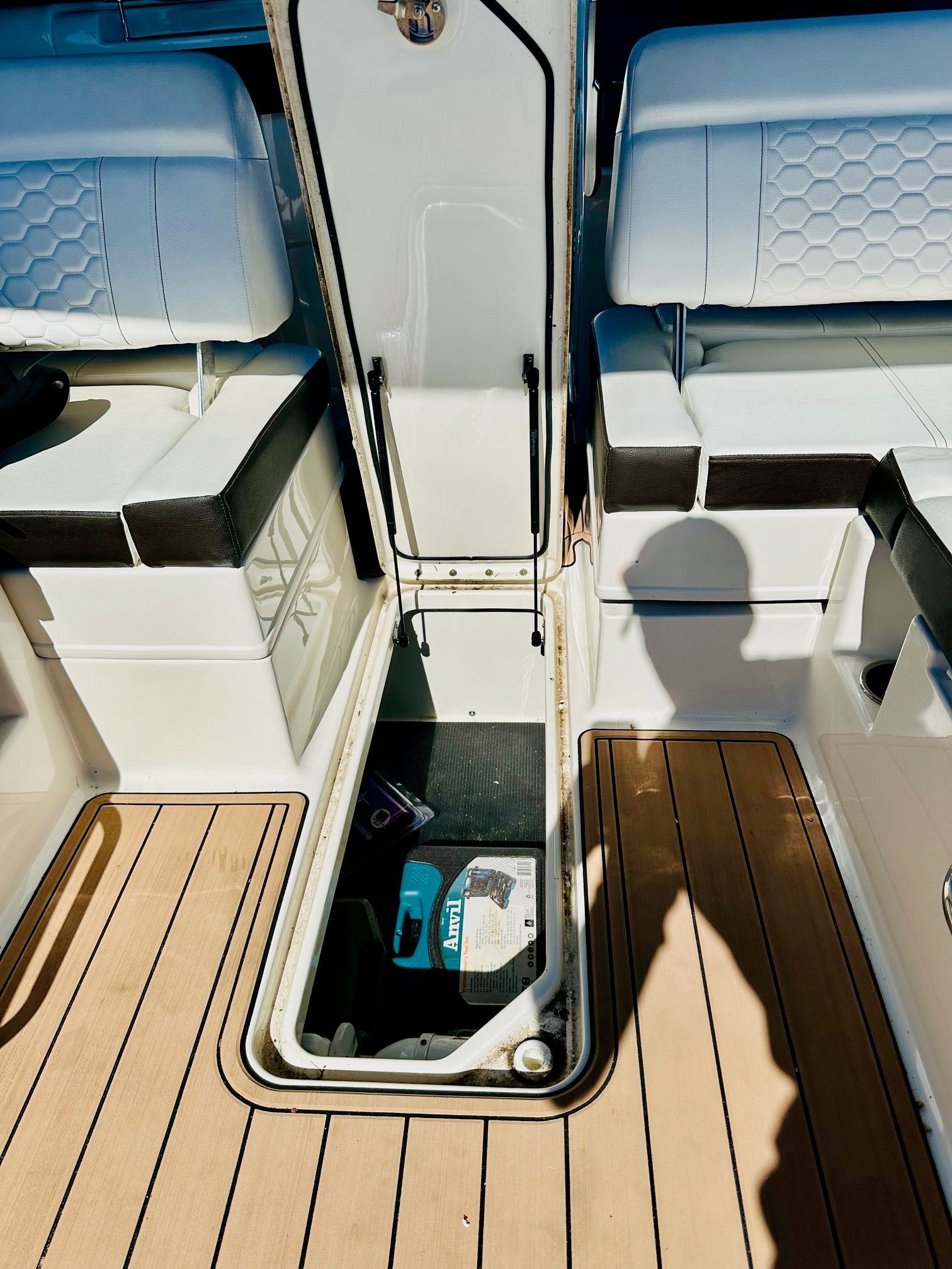An open storage compartment on a 2018 Sea Ray SDX 270 Outboard boat.