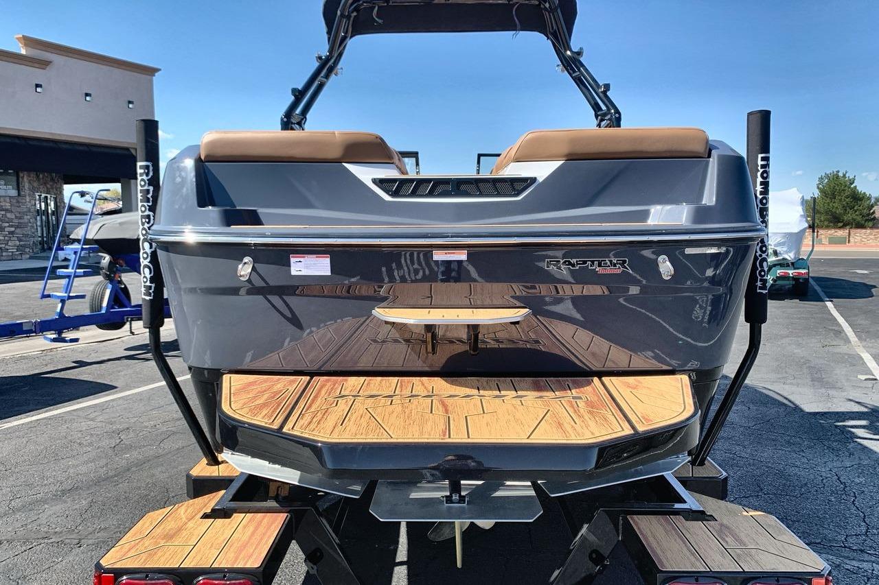 2026 Moomba Max boat rear view with wooden deck and Raptor engine branding.