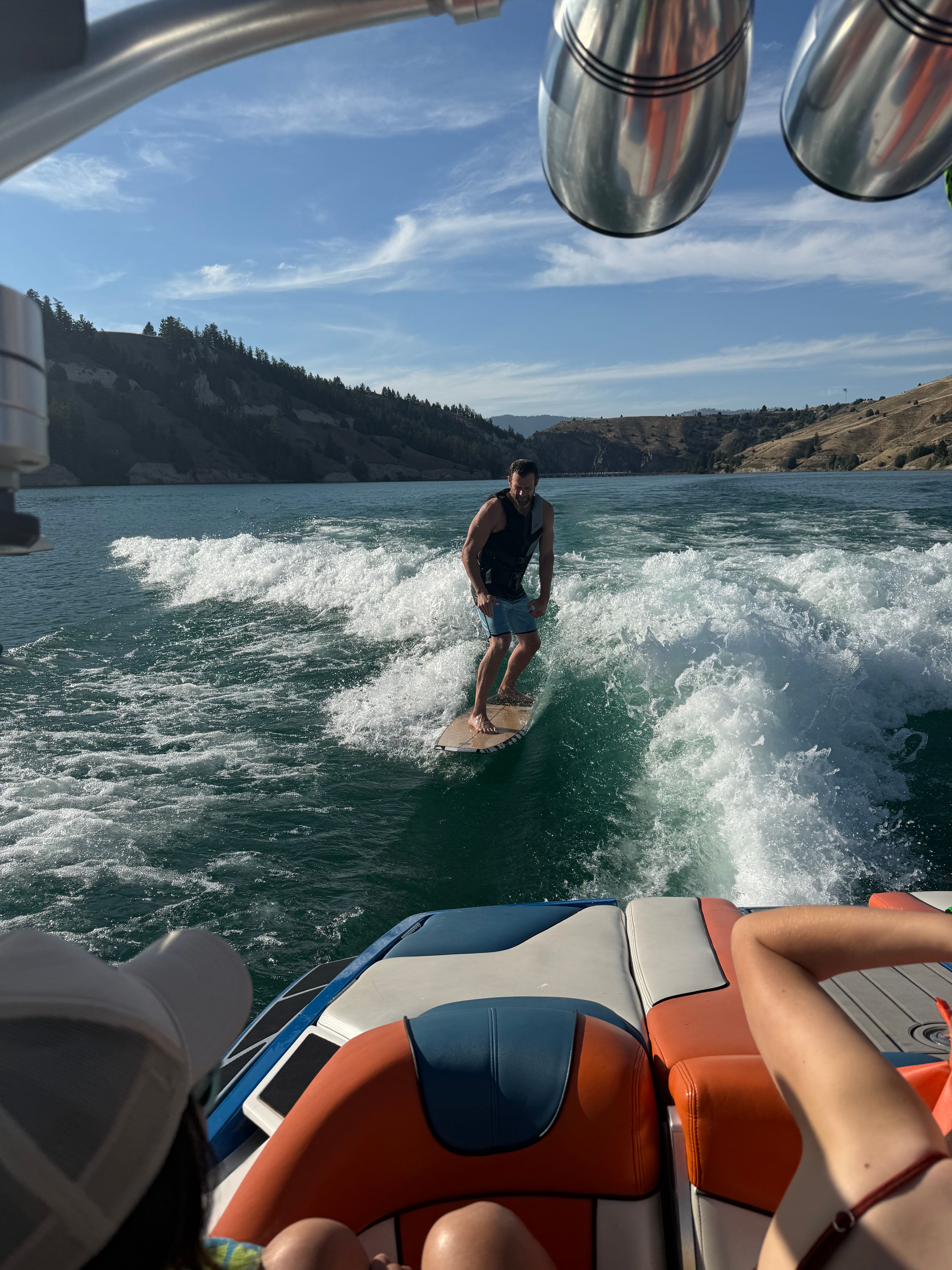 Person surfing behind a 2013 MasterCraft XStar boat.