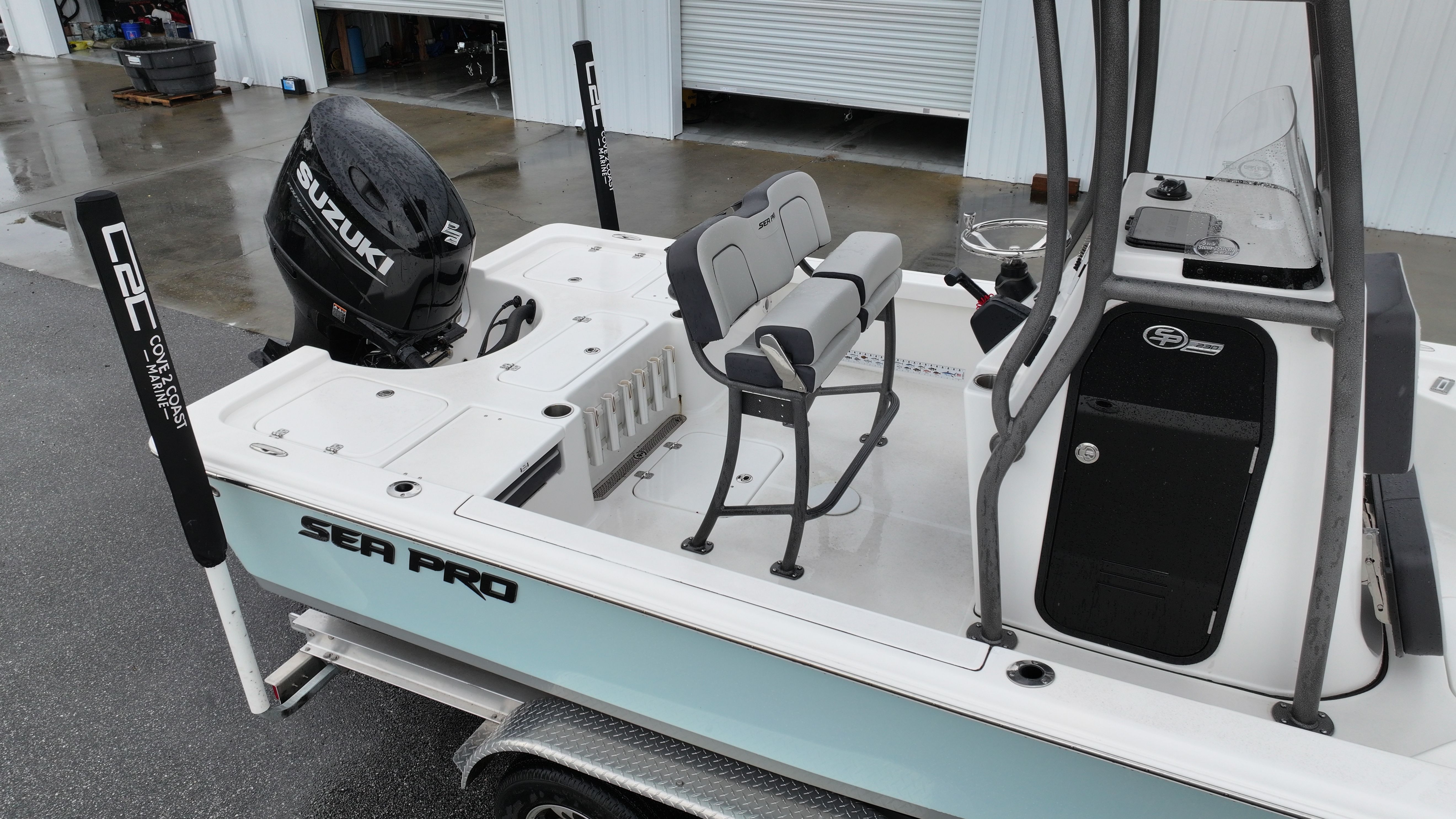 Sea Pro 230 DLX 2025 on a trailer, featuring a Suzuki engine.