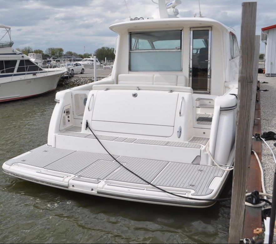 A 2005 Tiara Yachts 5200 Sovran docked. It features a spacious aft deck.