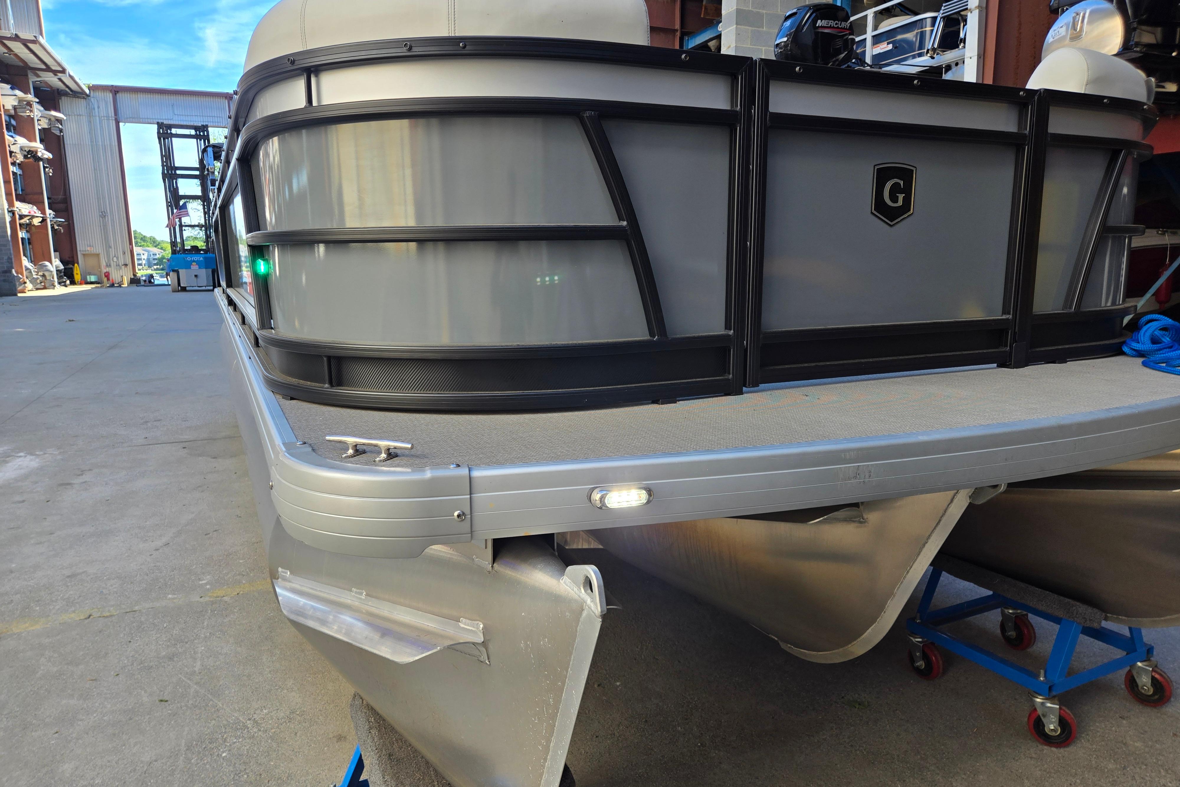 2024 Godfrey Sweetwater 2486 SB pontoon boat in a marina setting.