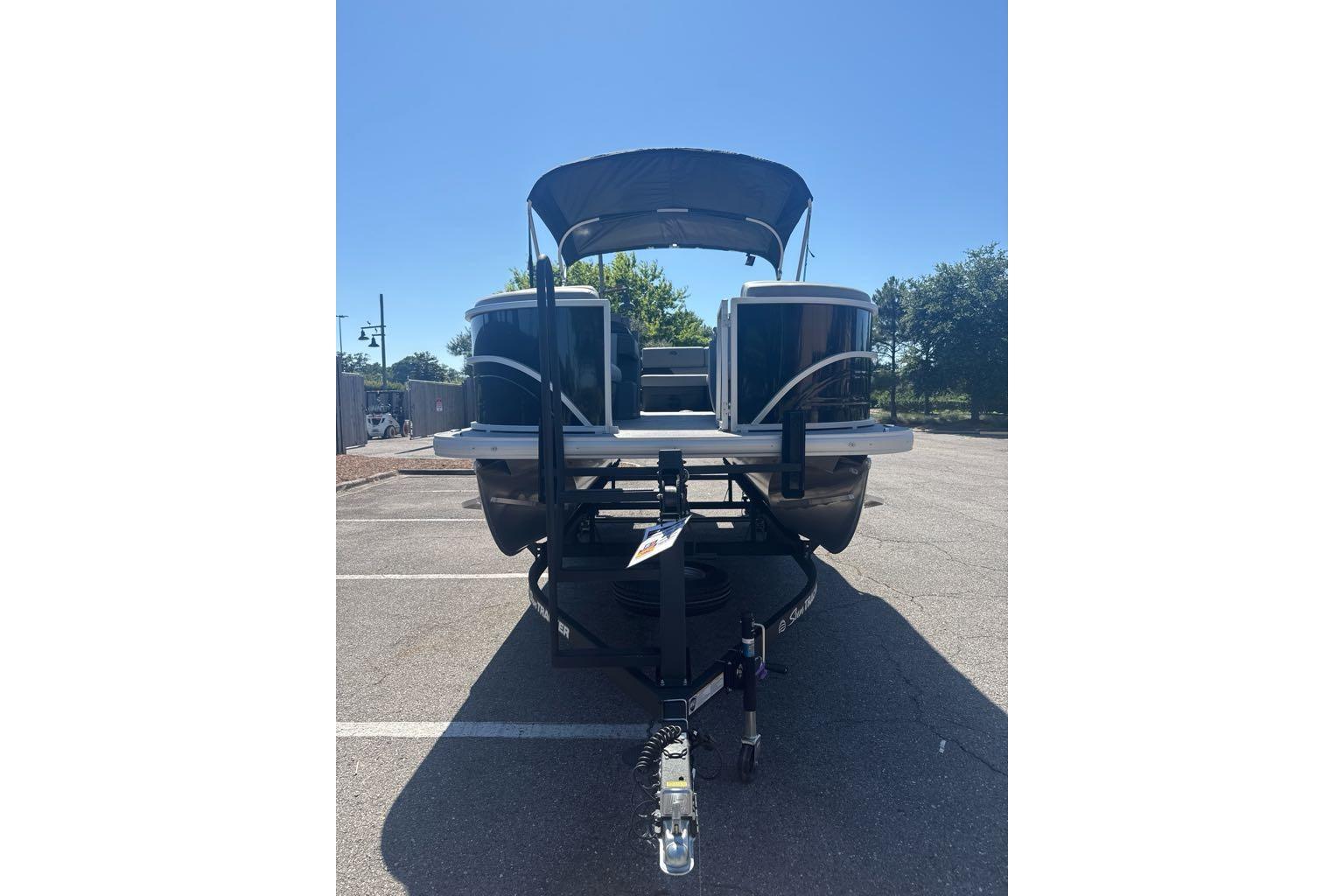 2026 Sun Tracker Party Barge 20 DLX pontoon boat in parking lot, front view.