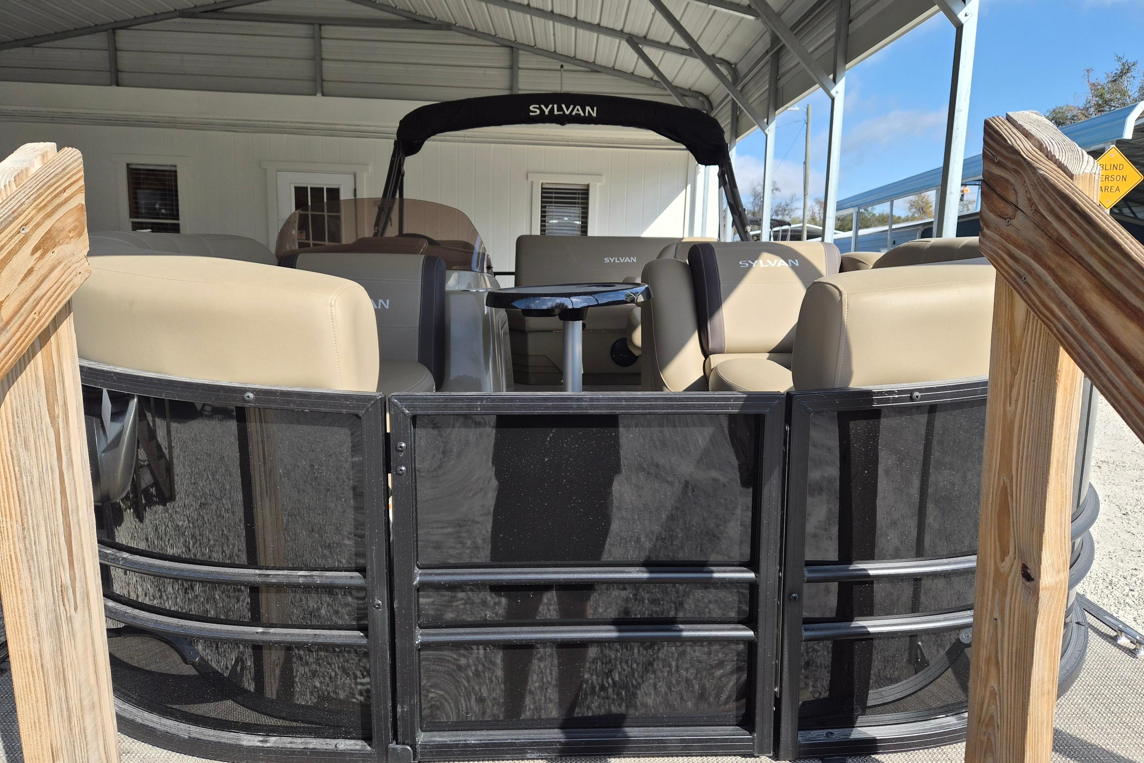 2026 Sylvan Mirage 820 CLZ DH pontoon boat under a metal canopy.