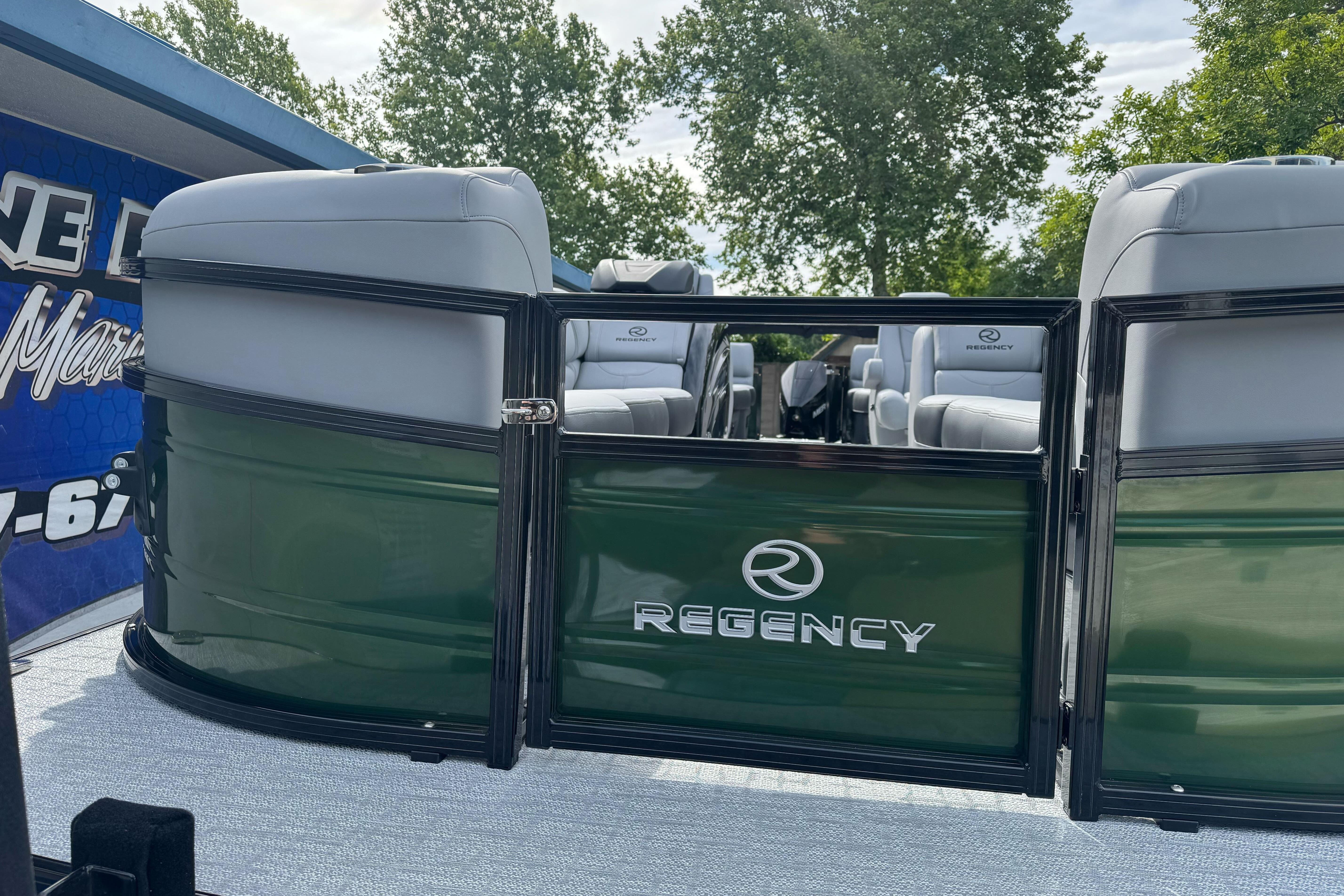 2026 Regency 250 DL pontoon boat with sleek green exterior and comfortable seating.