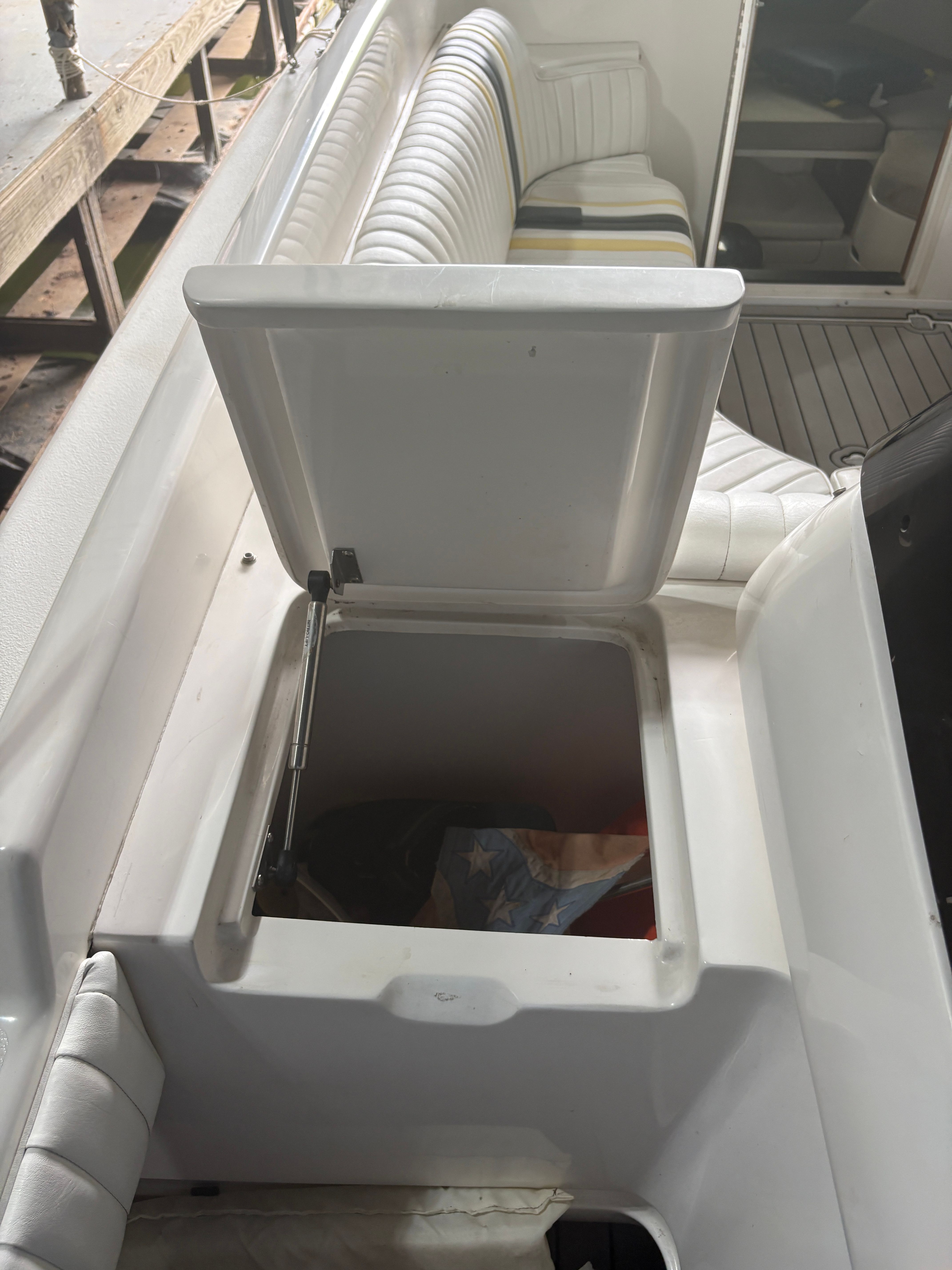 Intrepid 322 Cuddy Center Console 2002 with open storage compartment.