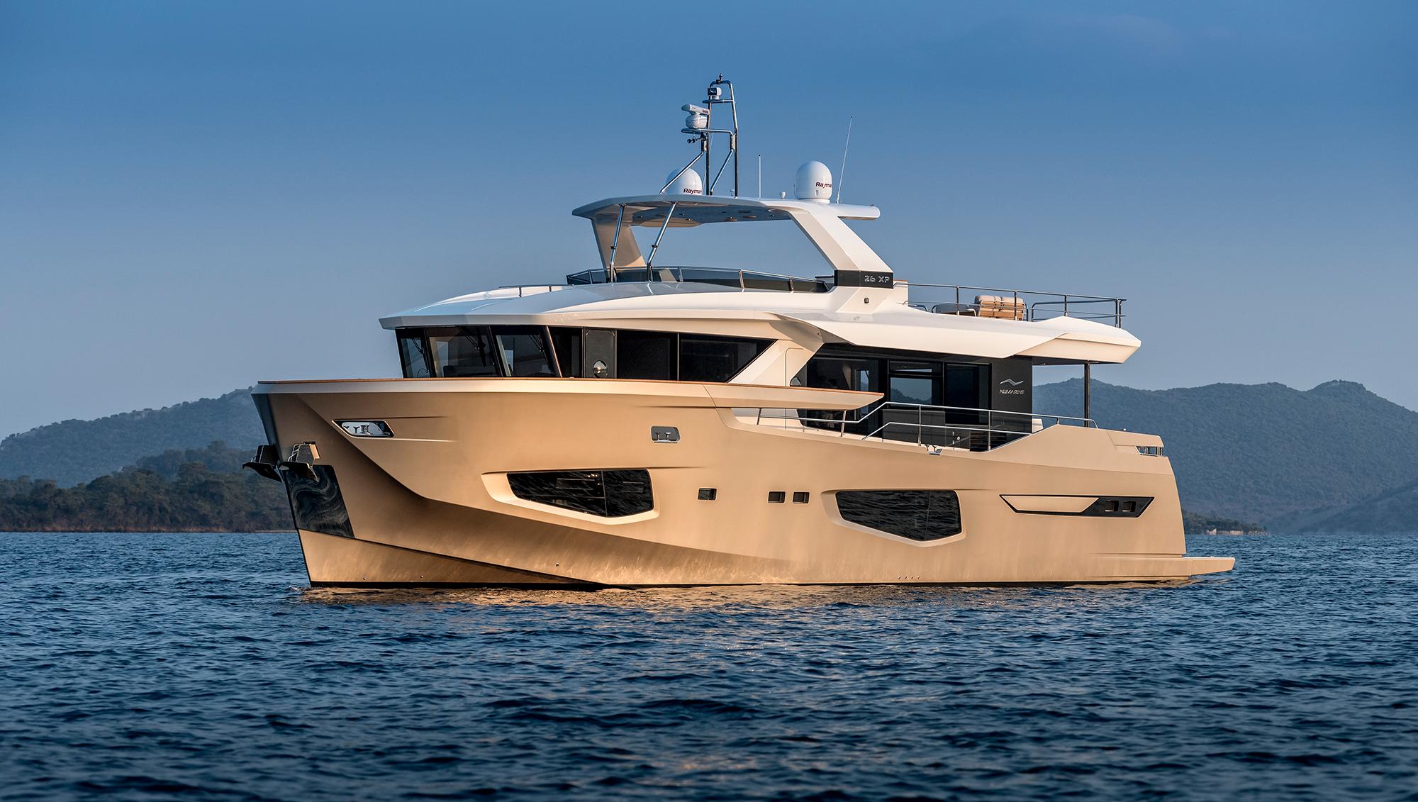 Luxury 2025 Numarine 26XP yacht cruising on serene waters, scenic mountain backdrop.
