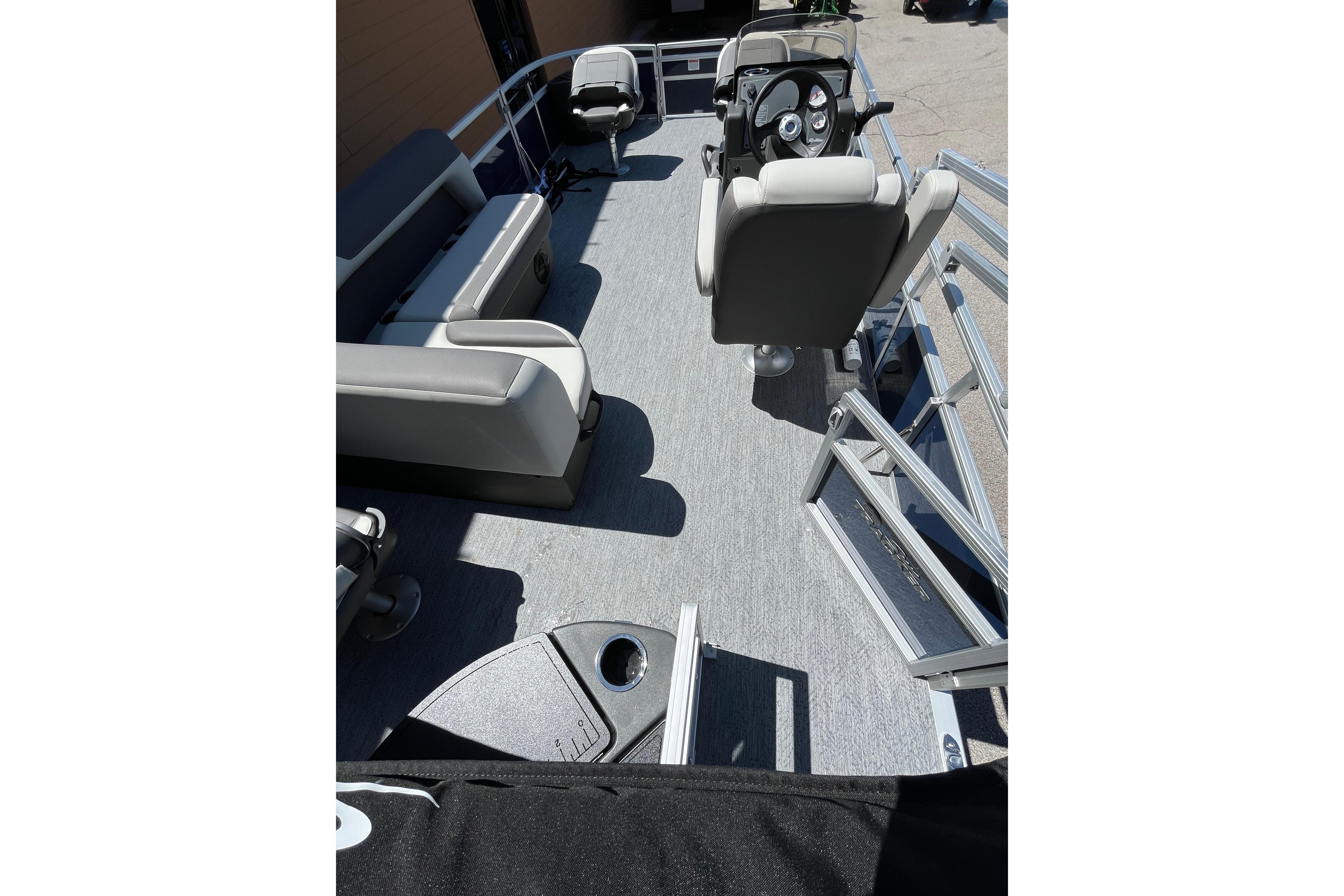 2026 Sun Tracker Bass Buggy 18 DLX pontoon boat interior with seating and steering console.