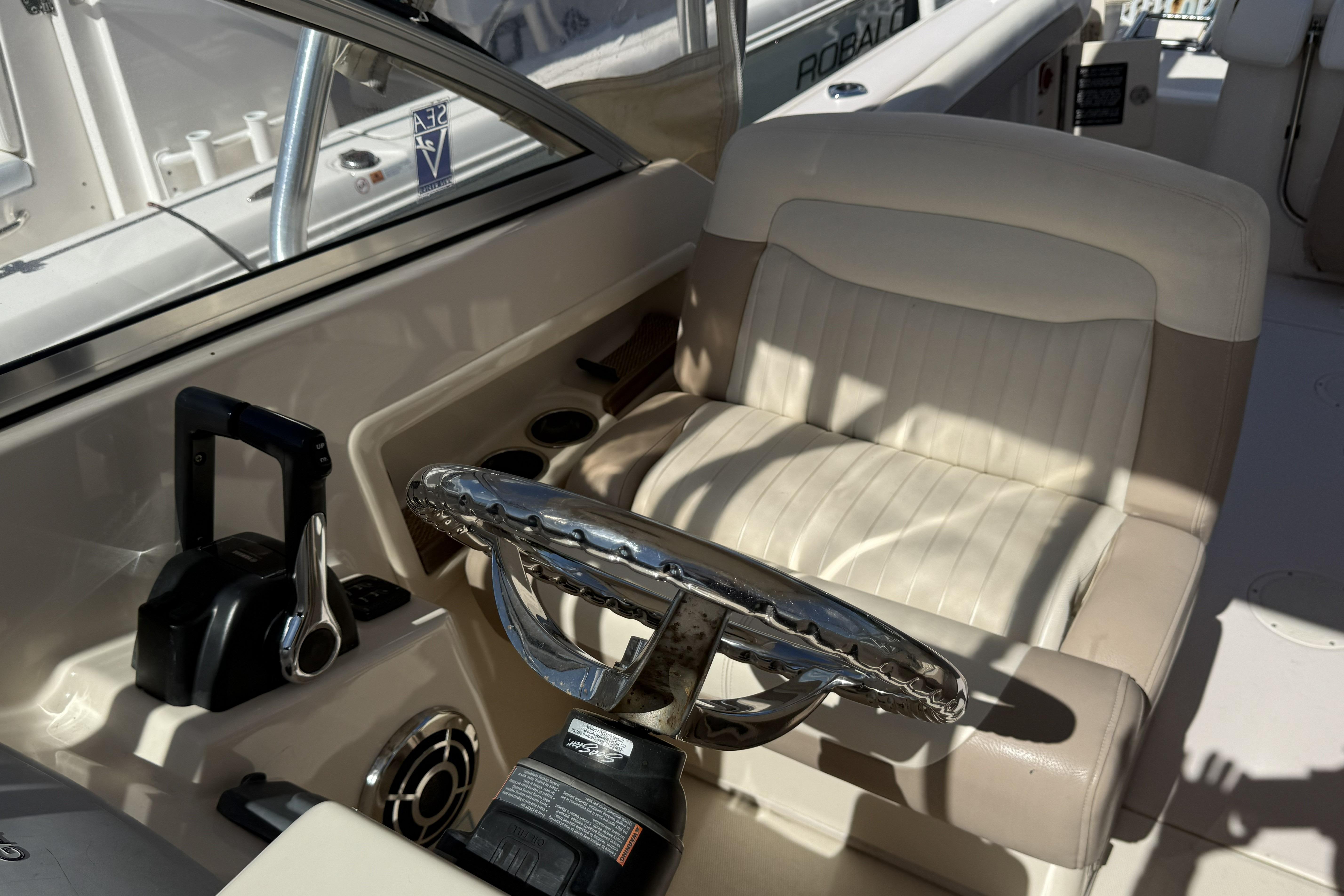 2014 Grady-White Freedom 275 boat cockpit with steering wheel and control panel.