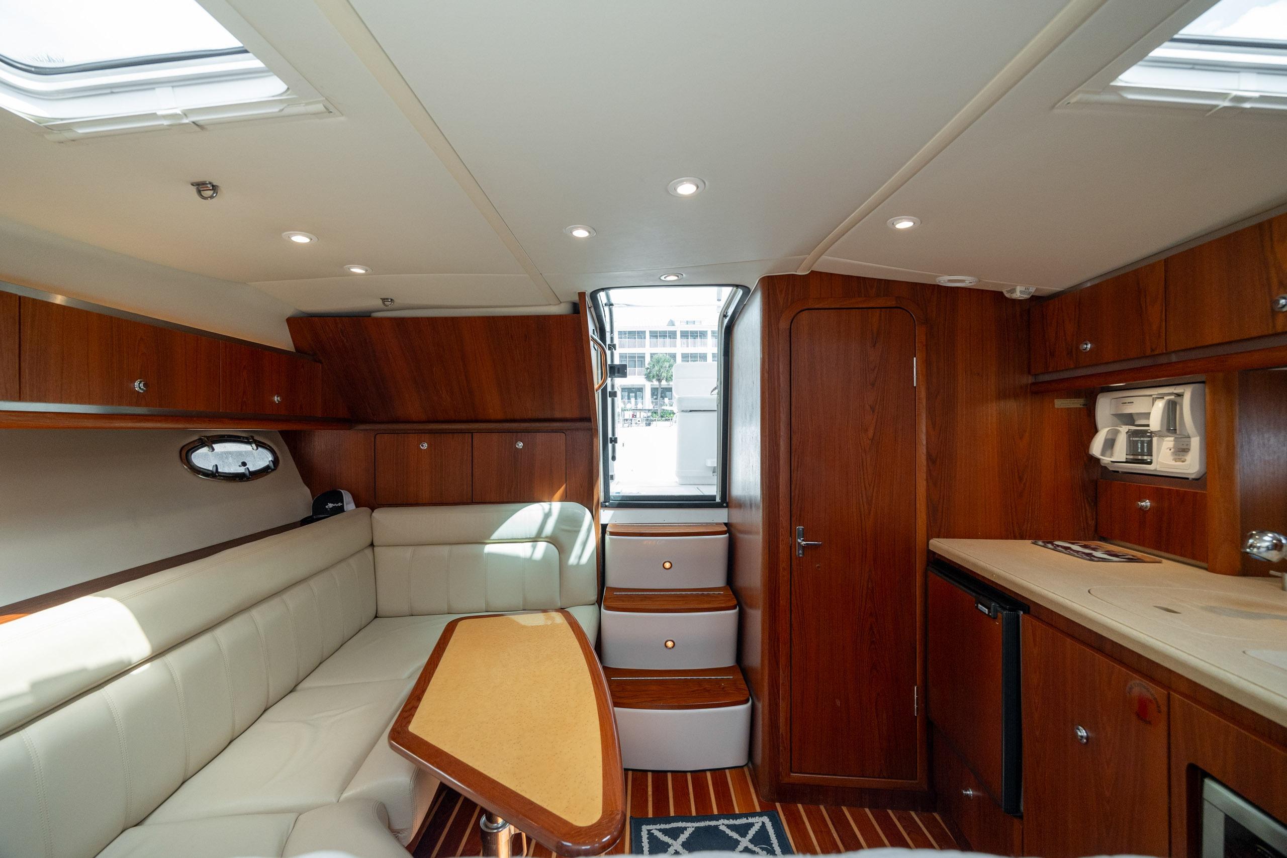 Luxurious interior of 2004 Tiara Yachts 3200 Open, featuring elegant wood finishes and comfortable seating.