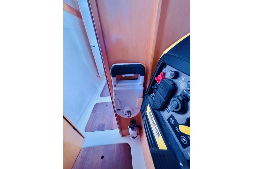 Interior of 2010 Fountaine Pajot Mahe catamaran showing control panel and wooden flooring.