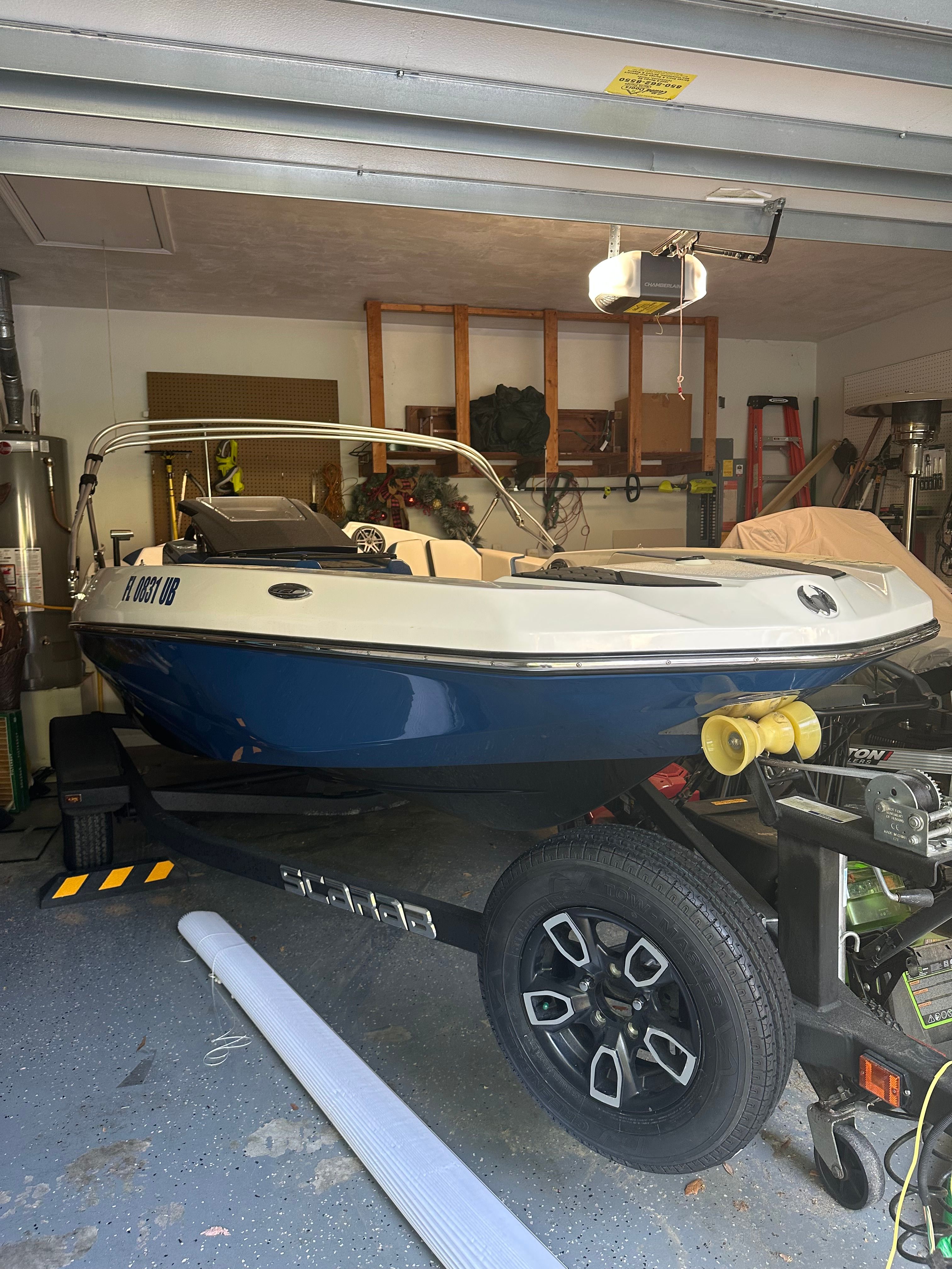 2023 Scarab Identity Jet boat in a garage on a trailer.