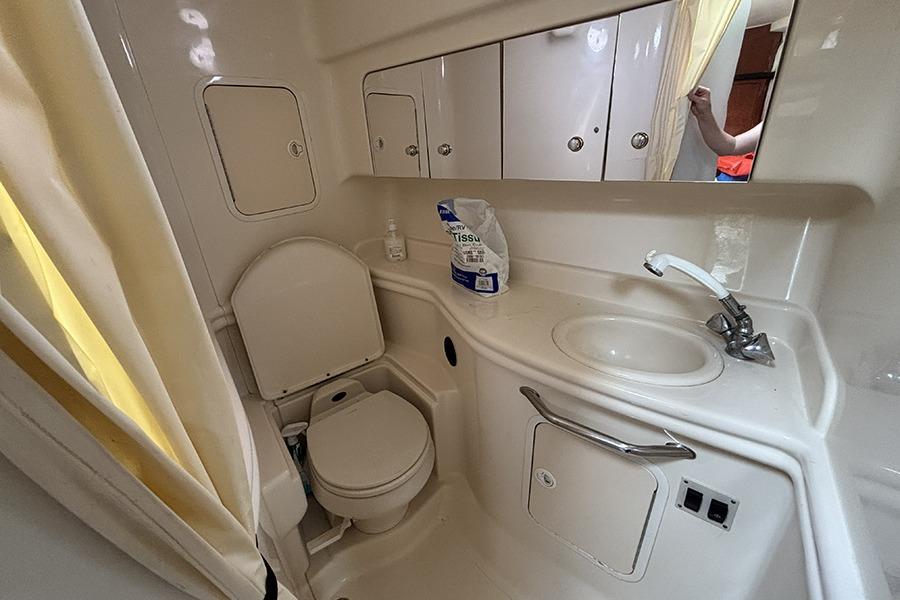 Bathroom interior of 2002 Sea Ray Sundancer 320 yacht with sink and toilet.