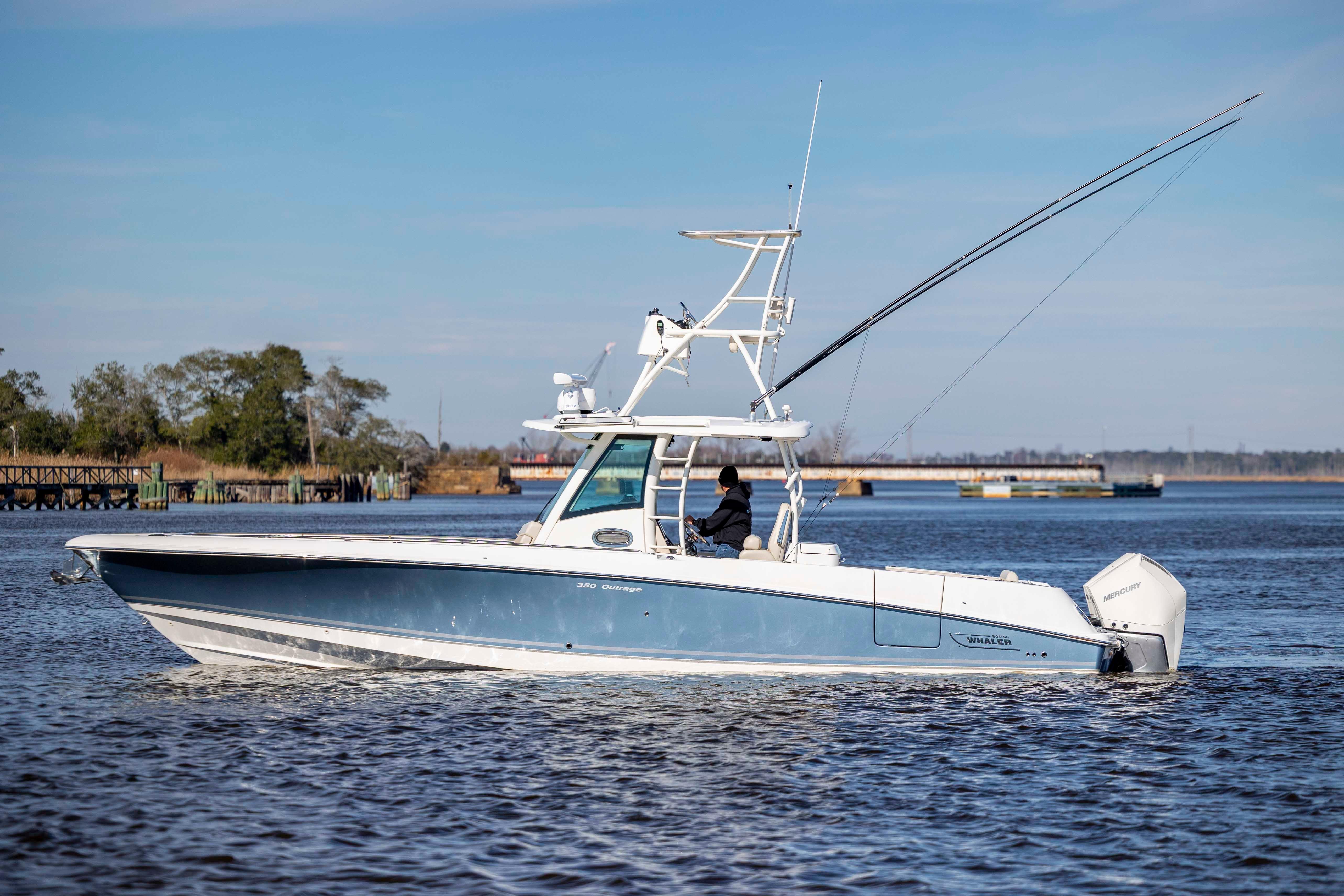 2019 Boston Whaler 350 Outrage boat cruising on a calm river.