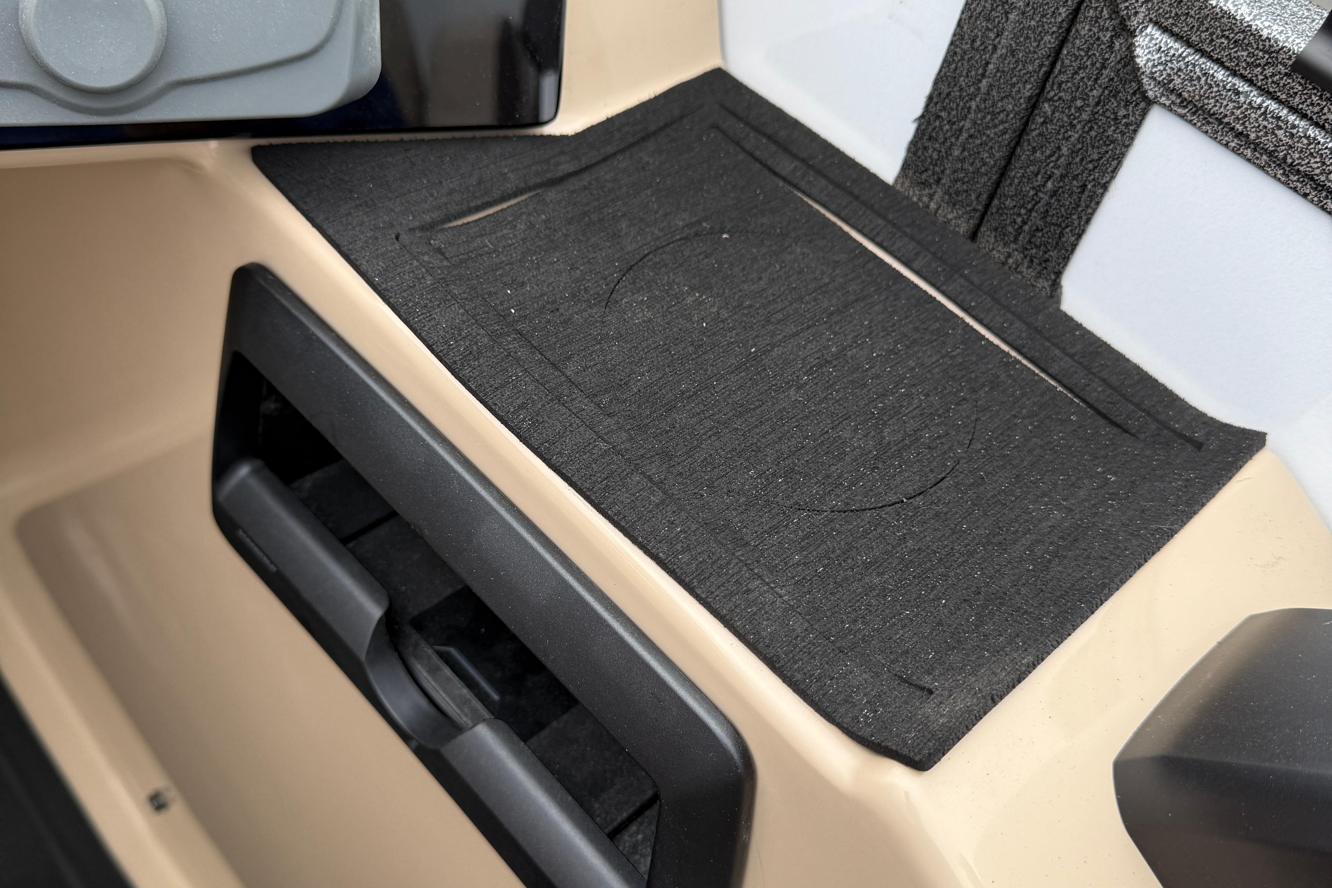 2026 Bentley Pontoons Elite 253 Admiral interior detail with black mat and beige paneling.