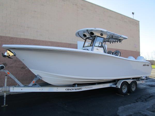 2025 Sea Pro 292 Offshore boat on trailer, parked outdoors.