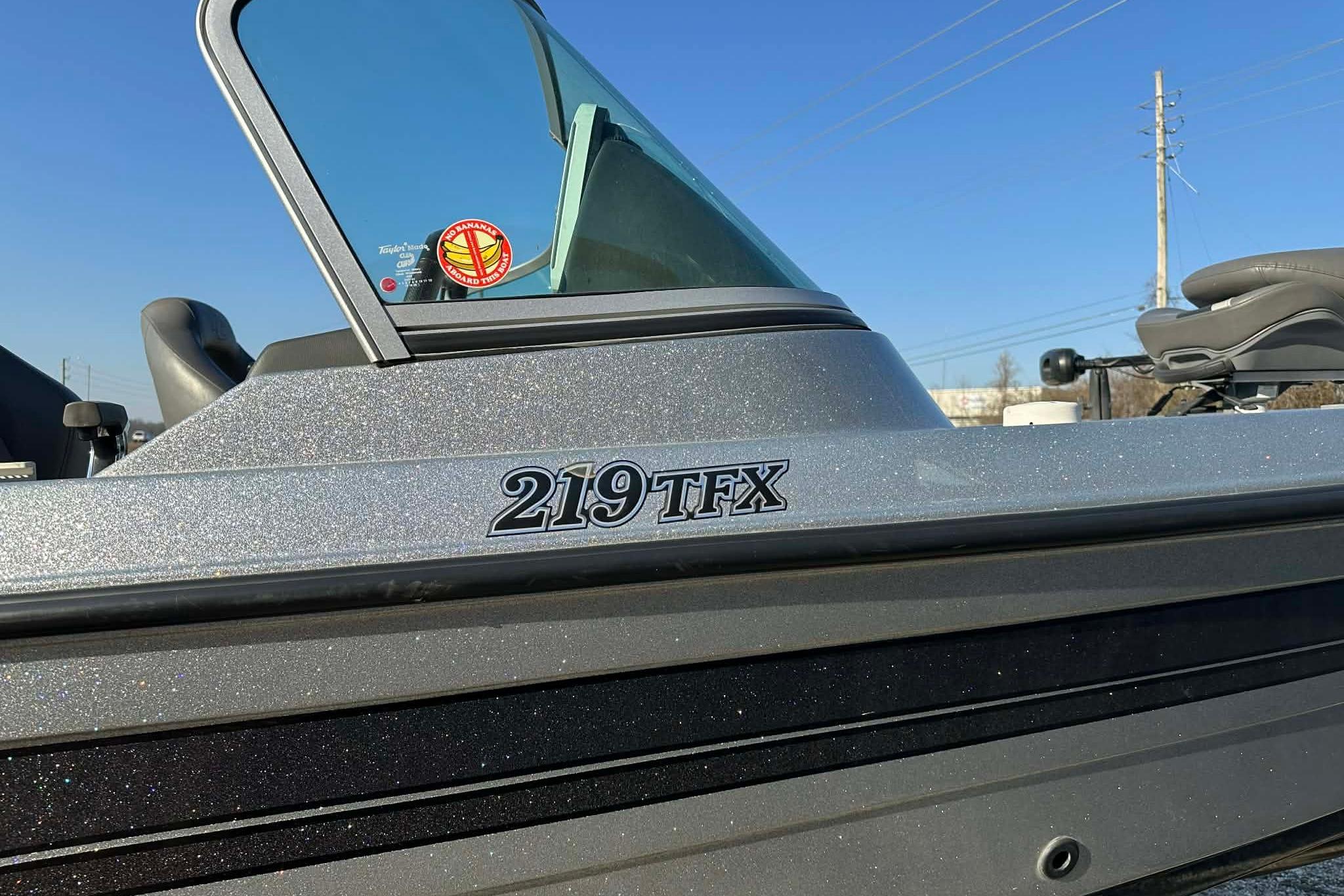 2018 Yar-Craft 219TFX boat with windshield and logo, under clear blue sky.