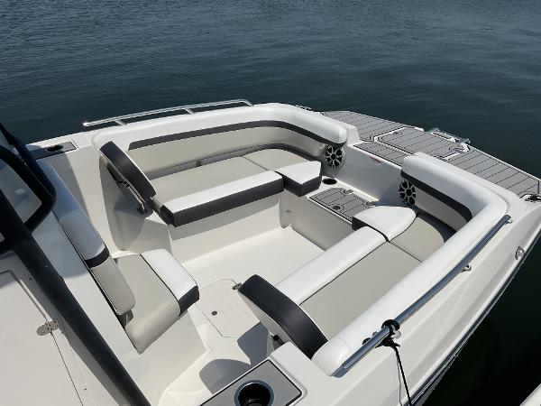 2025 Starcraft SVX 211 OB CC boat interior with cushioned seating, on calm water.