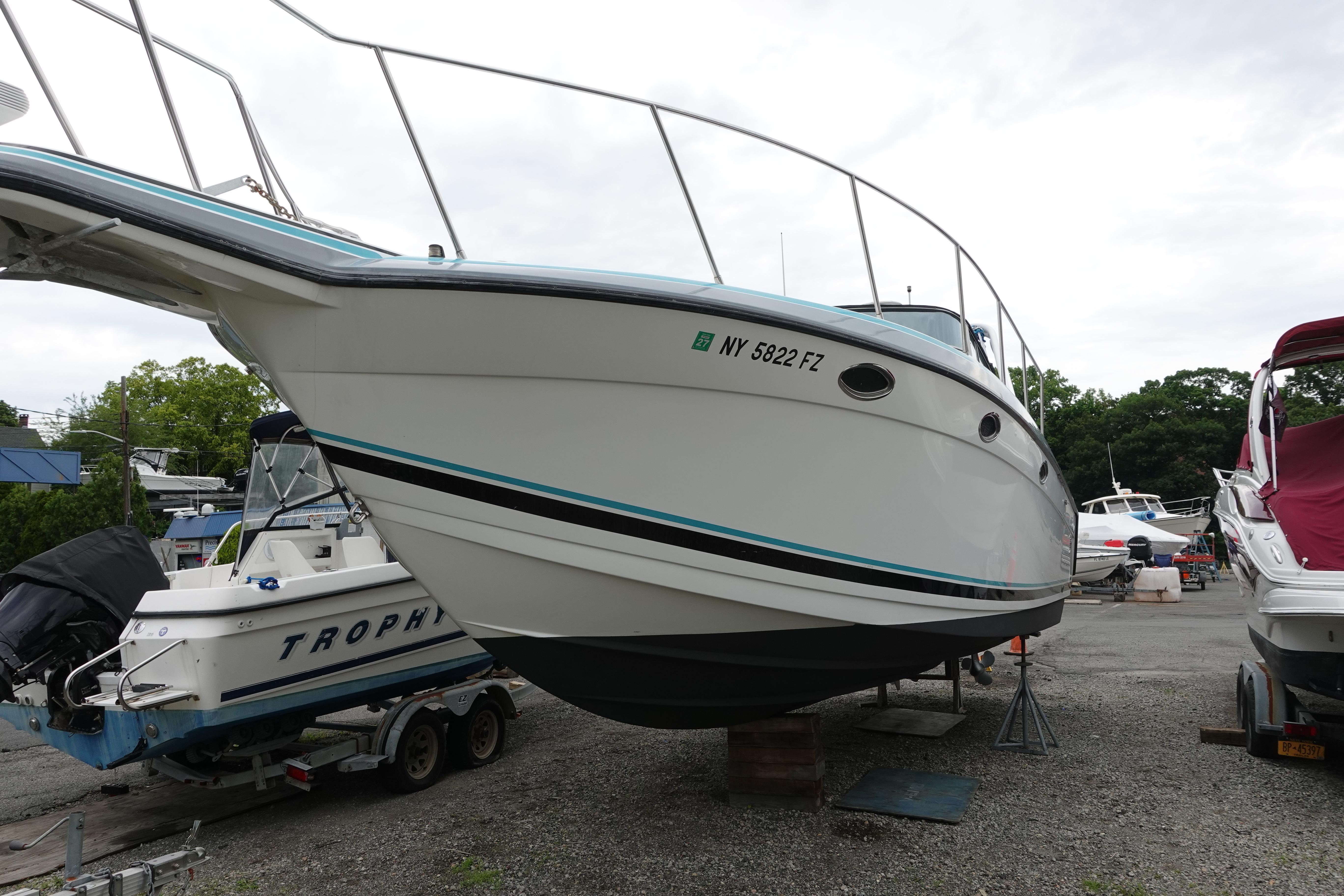 1993 Formula 34 Performance Cruiser boat on dry dock, surrounded by other vessels.