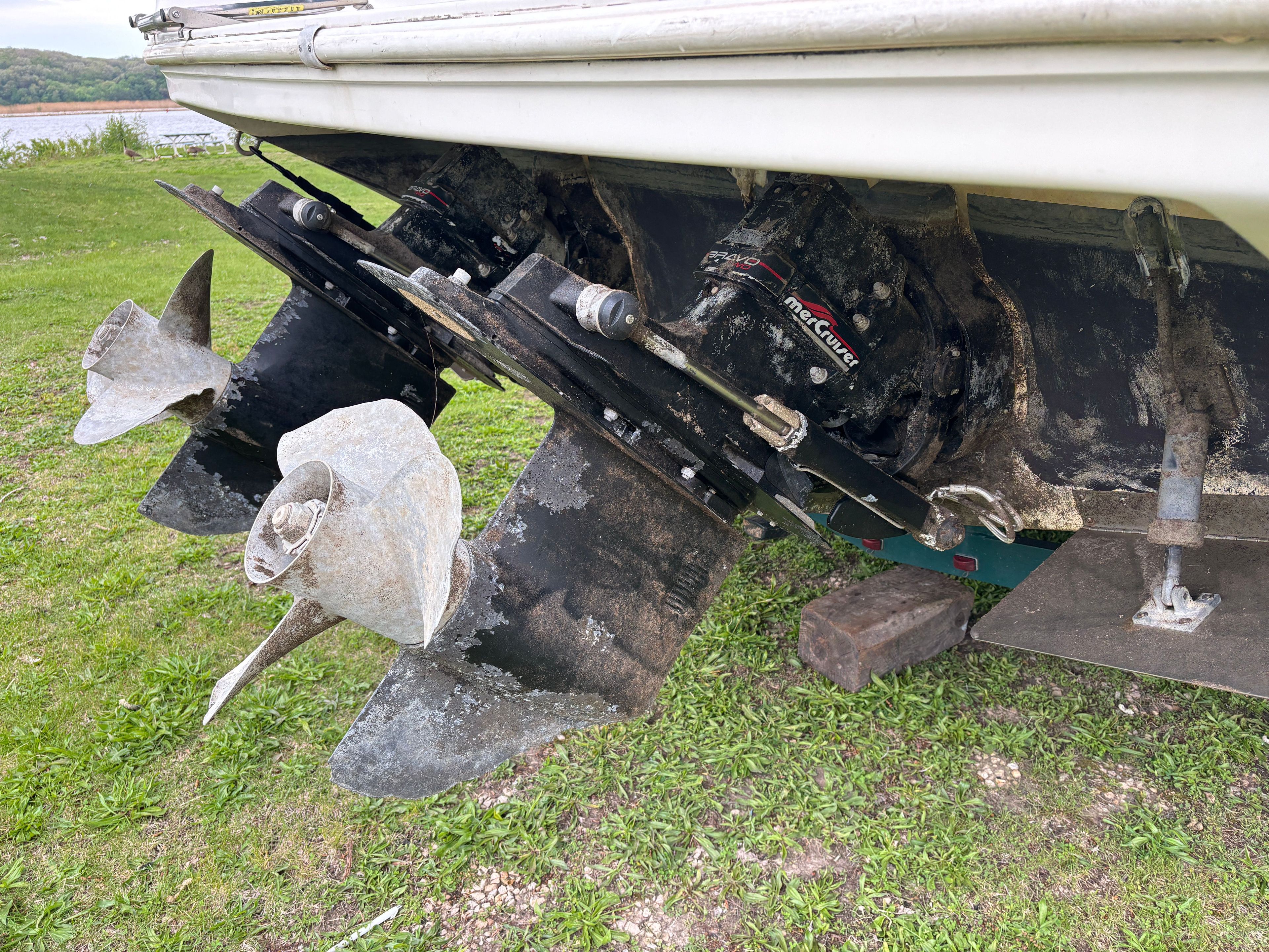 The image shows a boat's drive system on grass.