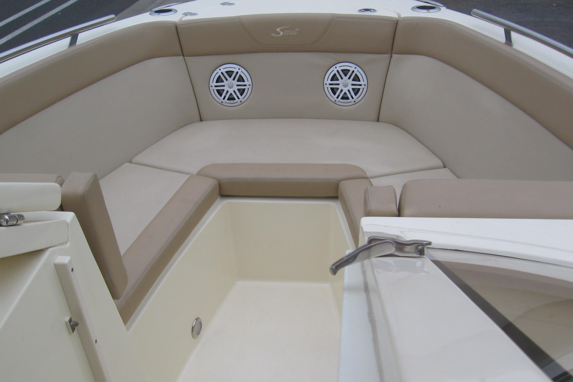 2024 Scout 255 Dorado boat interior with beige seating and built-in speakers.