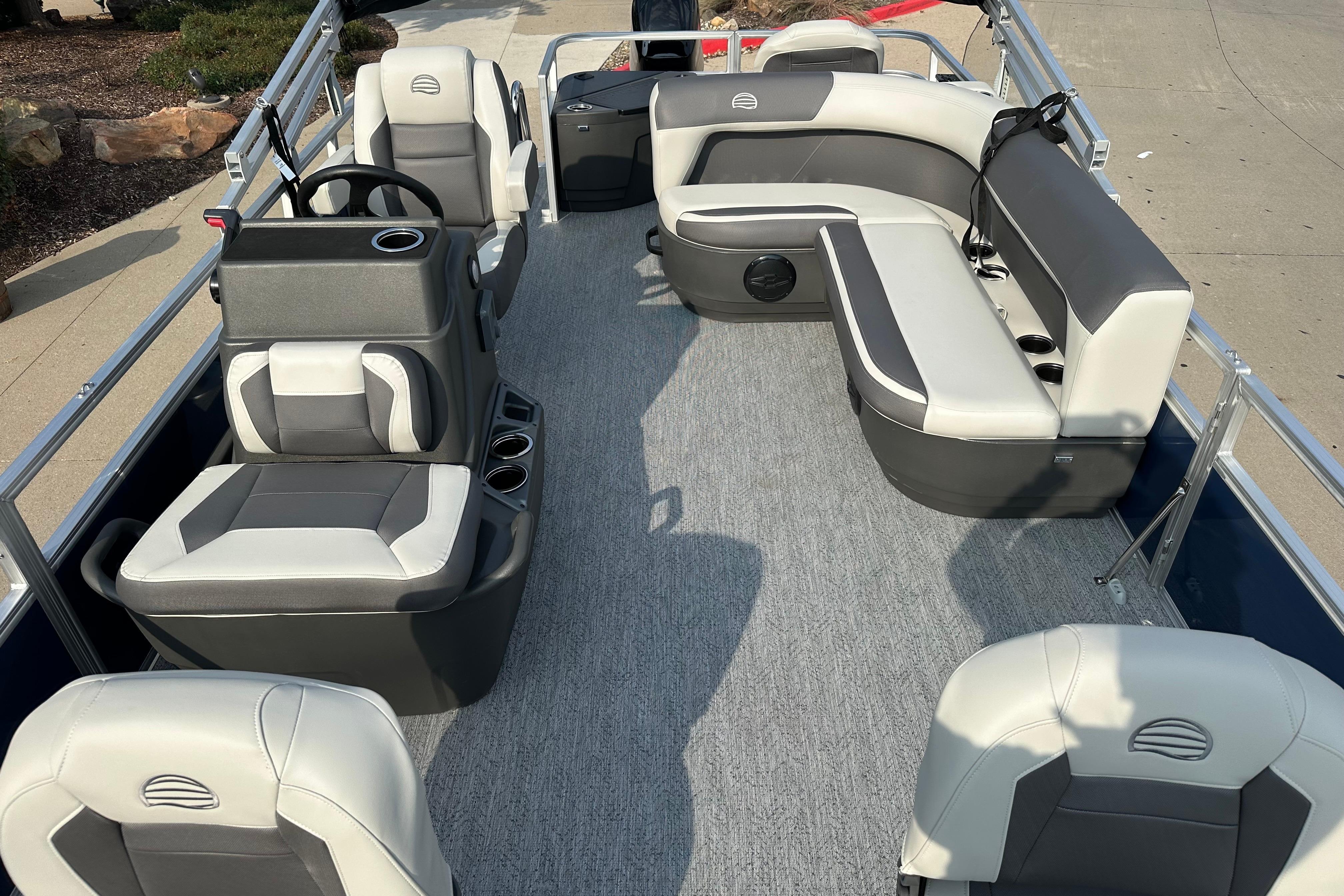 2026 Sun Tracker Bass Buggy 18 DLX pontoon boat interior with seating and steering console.