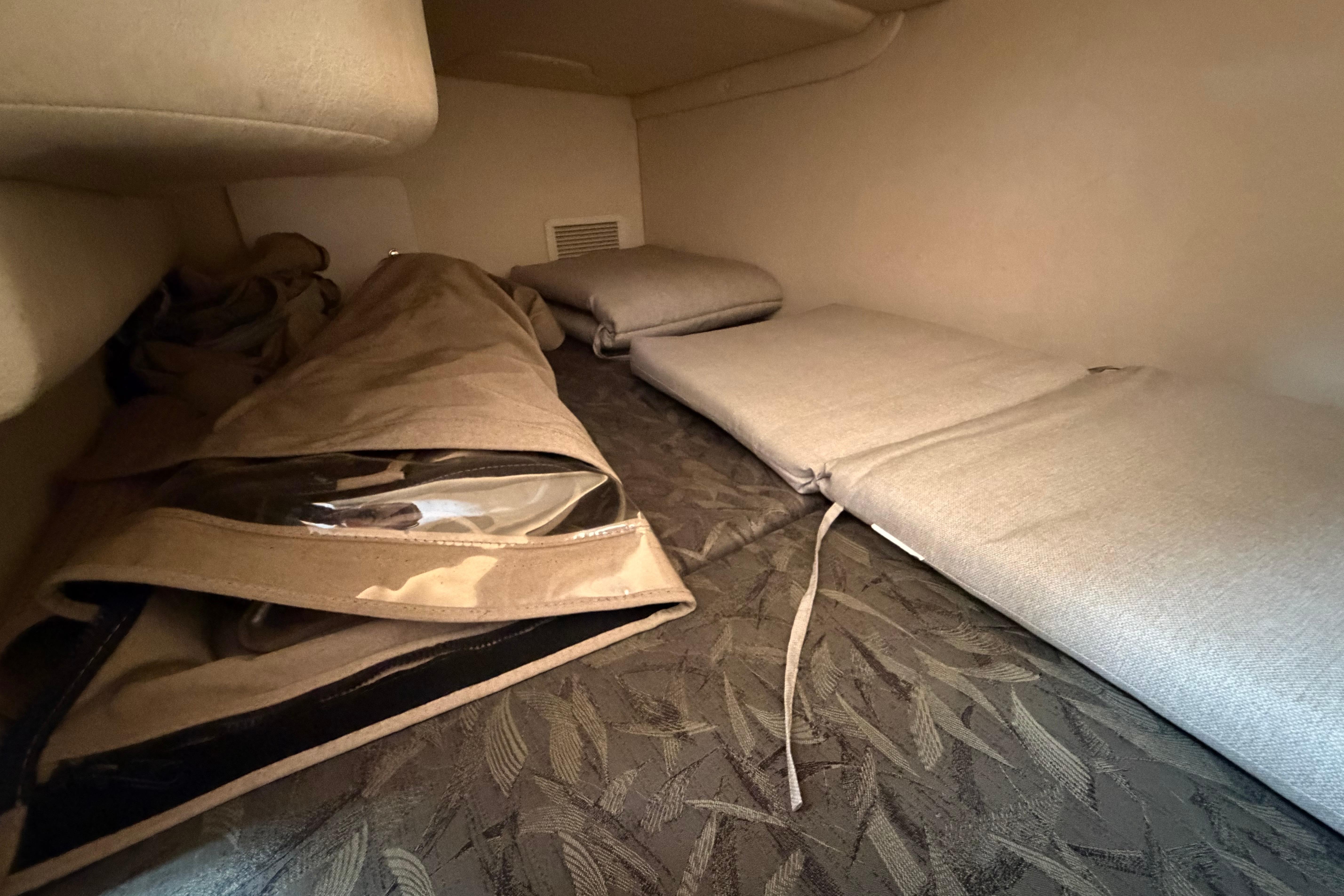 Interior cabin of 2004 Sea Ray Sundancer 260 with cushions and storage space.