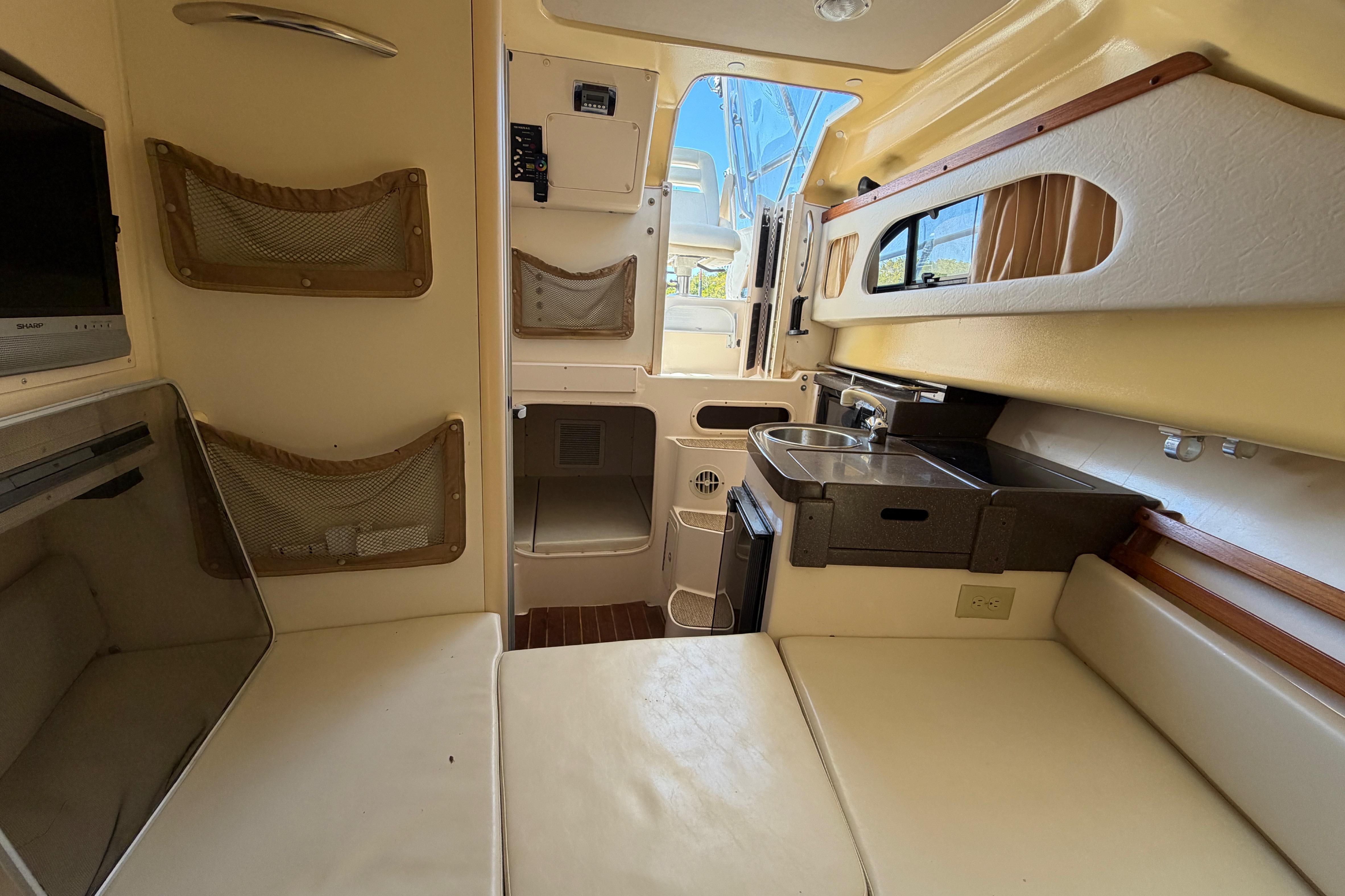 Interior of 2006 Grady-White Sailfish 282 boat with kitchenette and seating area.