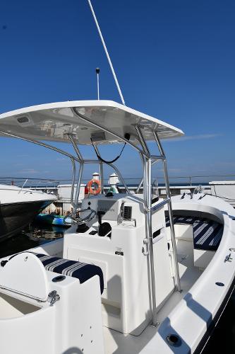 2021 Eastern 248 Center Console boat docked under clear blue sky.