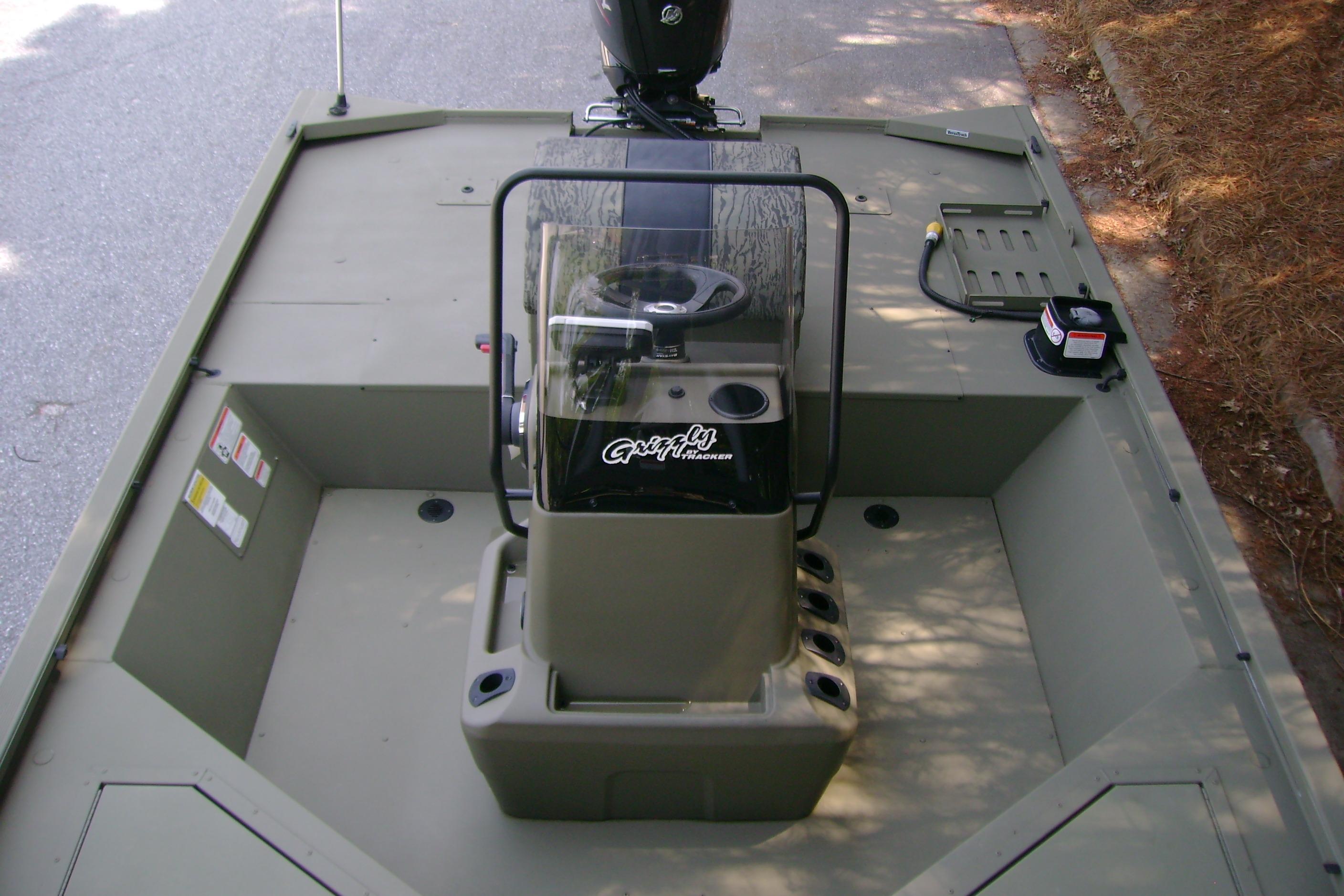 2026 Tracker Grizzly 2072 CC Sportsman boat interior with steering console and seating area.