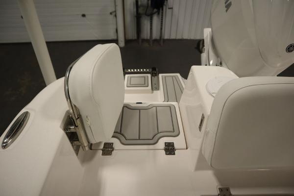 2025 Sea Fox 228 Commander boat interior with white seating and storage compartments.
