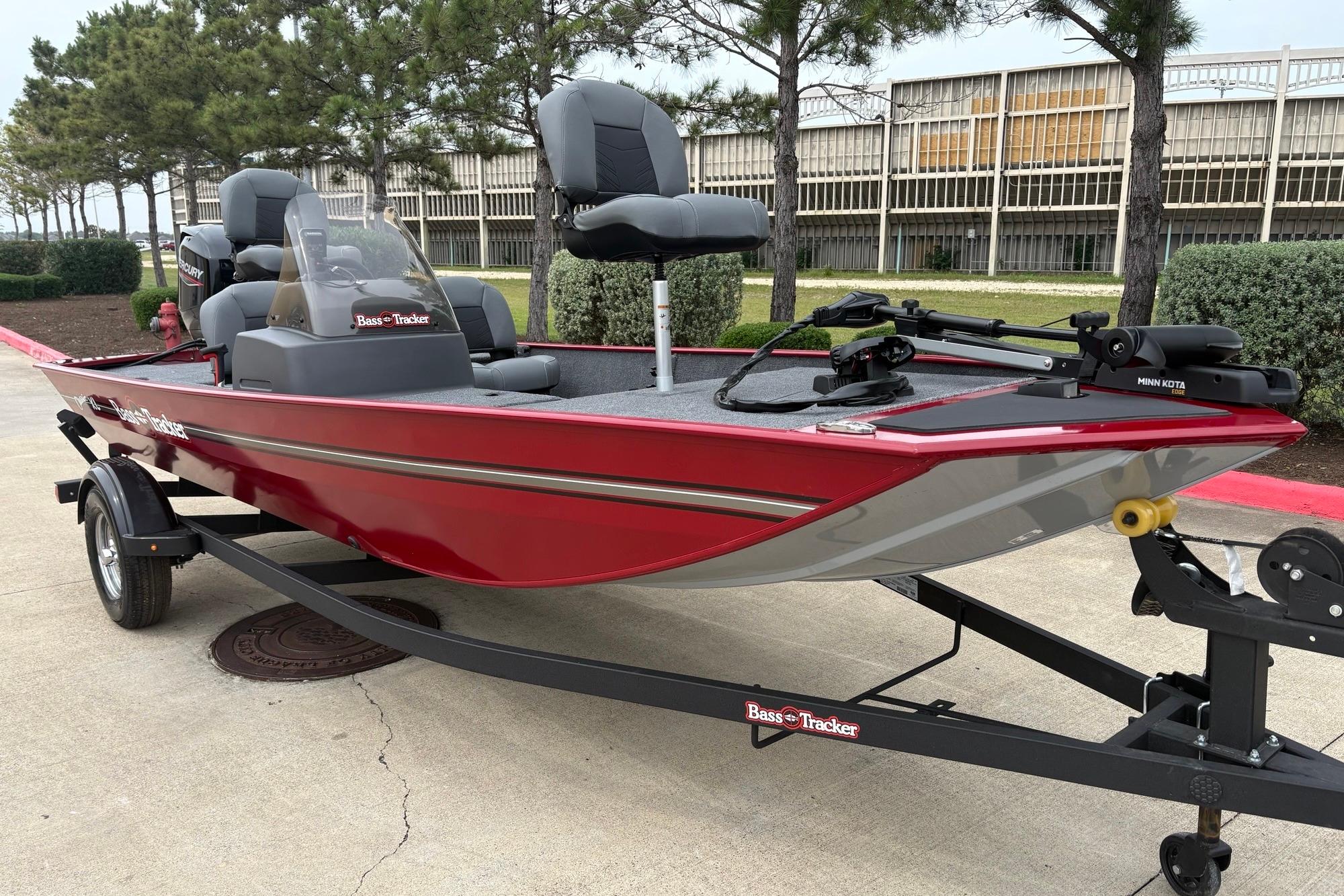 2026 Tracker Bass Tracker Classic XL boat on trailer, red exterior, parked outdoors.