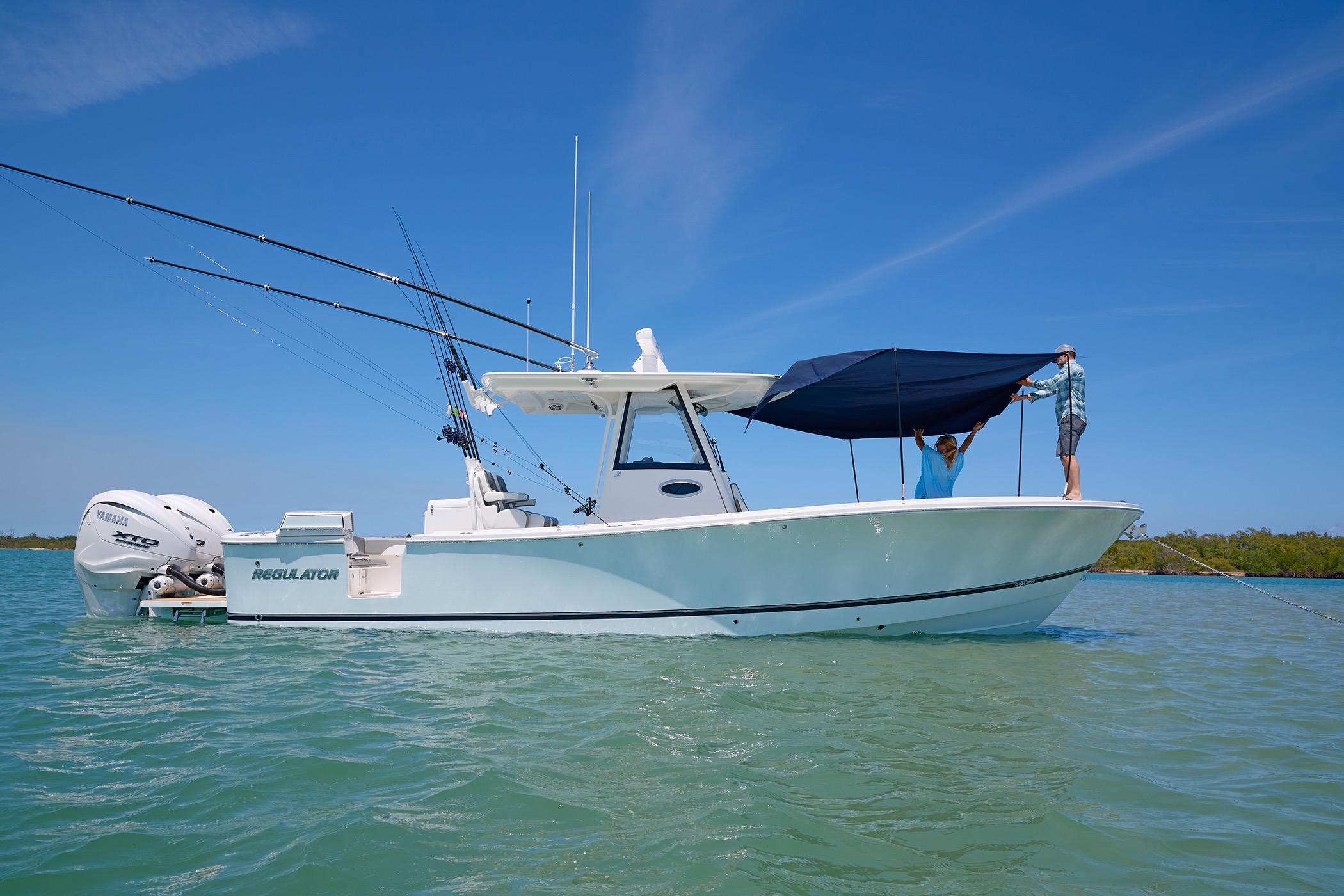 2025 Regulator 31 boat with canopy setup on calm water.