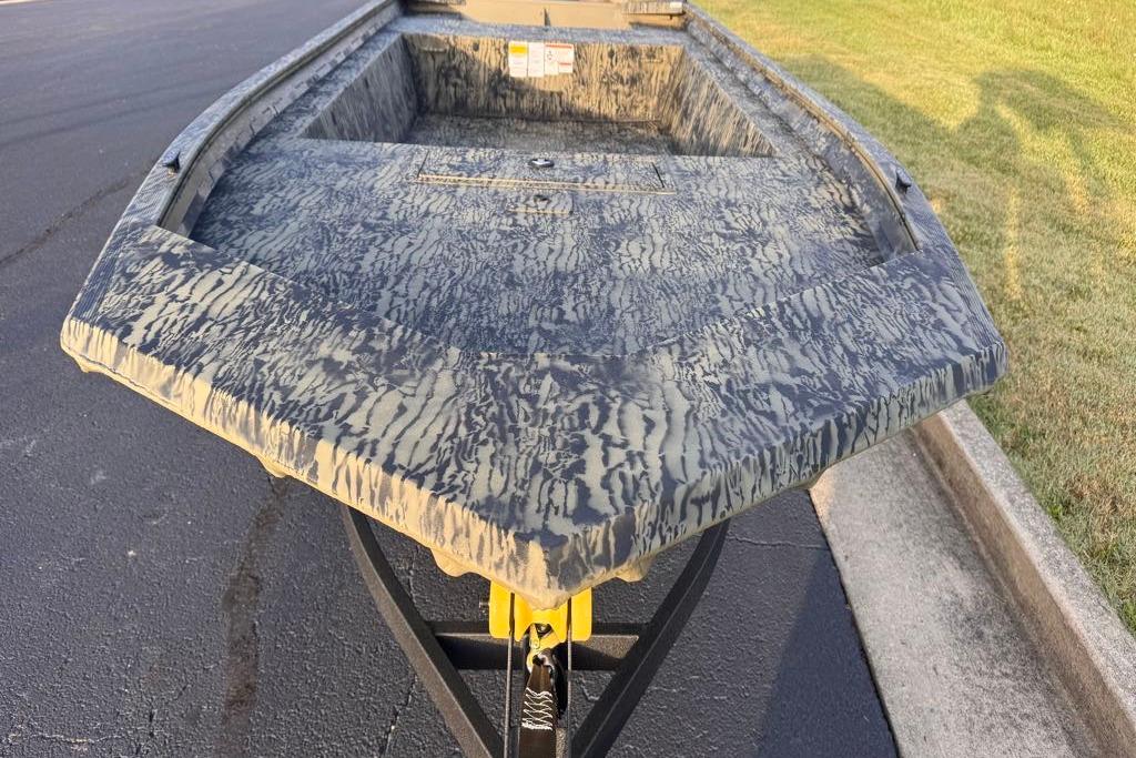 2026 Tracker Grizzly 1754 Utility boat with camouflage pattern on a trailer.