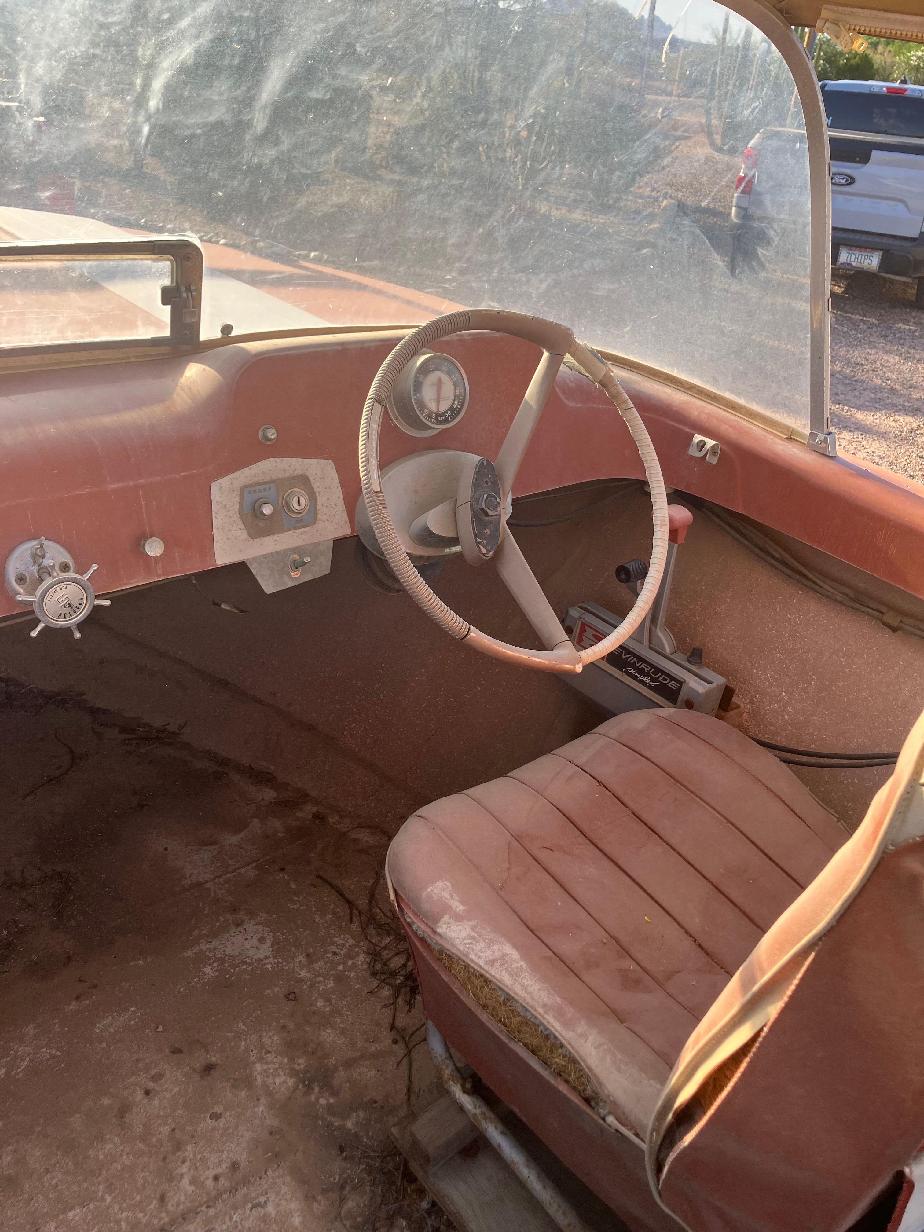 The image shows the cockpit of a 1958 Hydroswift Runabout with a steering wheel and seat.