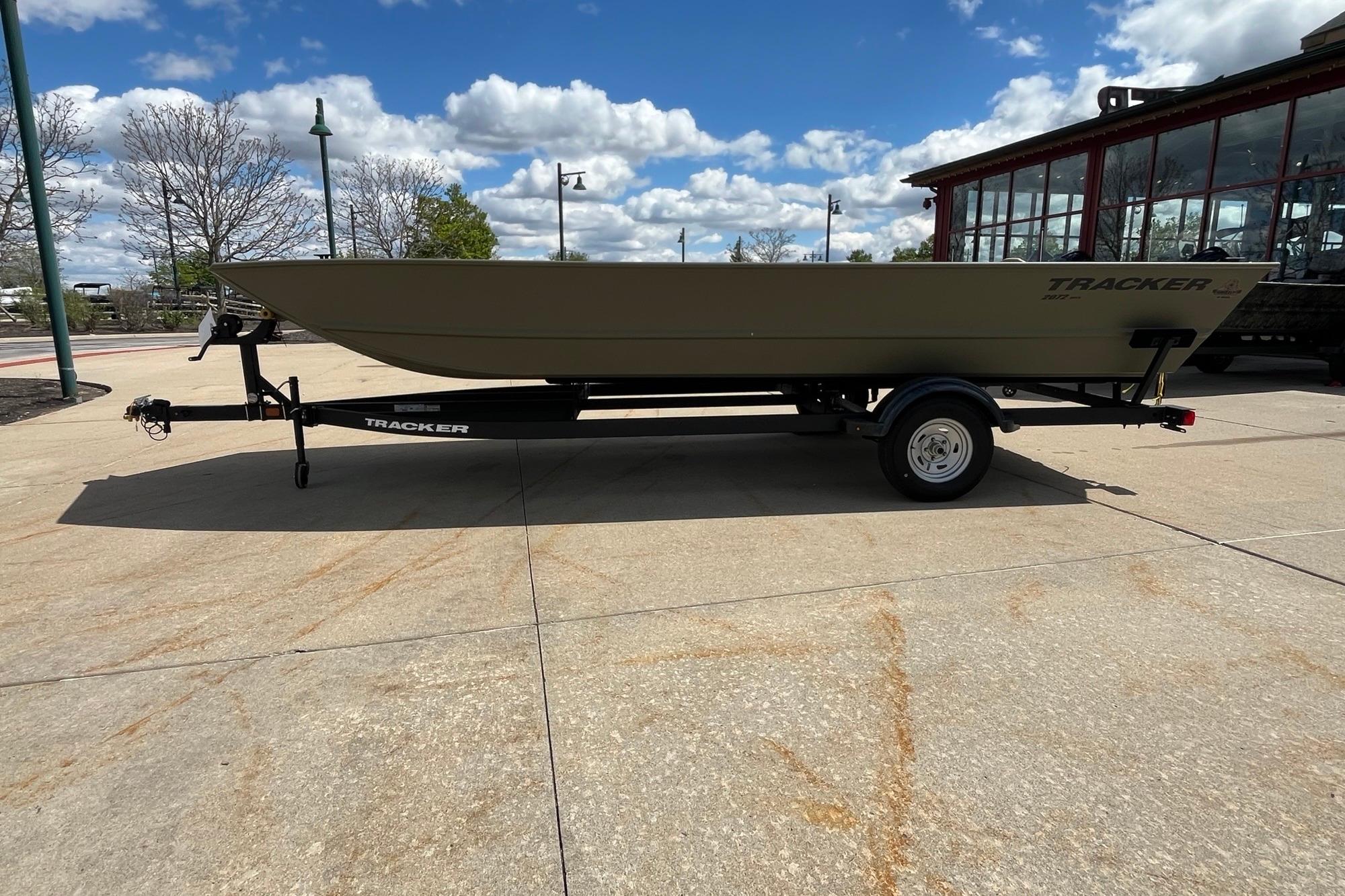 2026 Tracker Grizzly 2072 Utility boat on trailer under a clear blue sky.