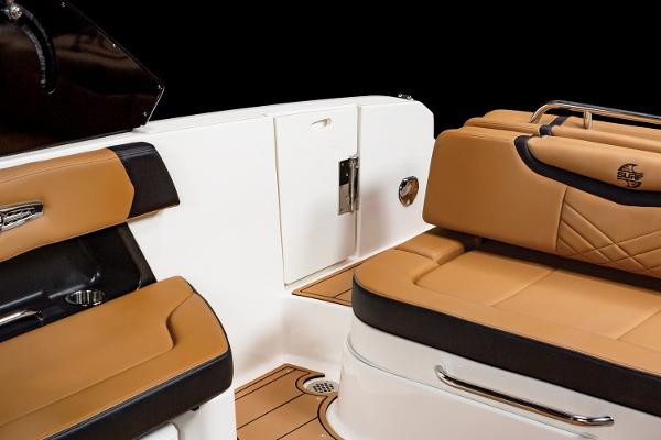 2024 Chaparral 28 Surf boat interior with tan and black seating.