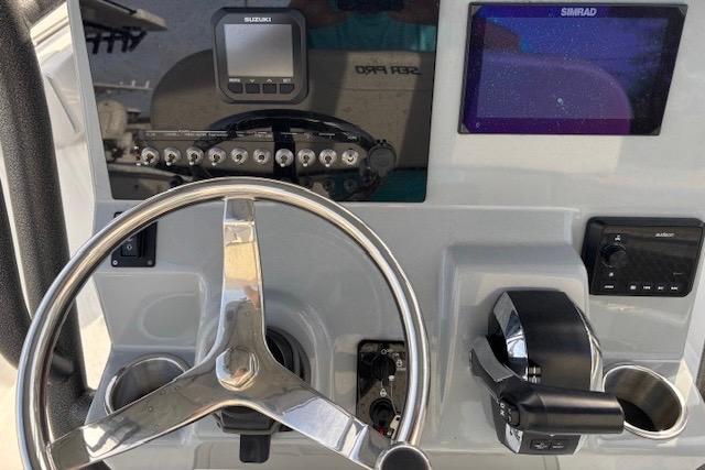 2025 Sea Pro 225FLX Sandbar boat dashboard with steering wheel and control panel.