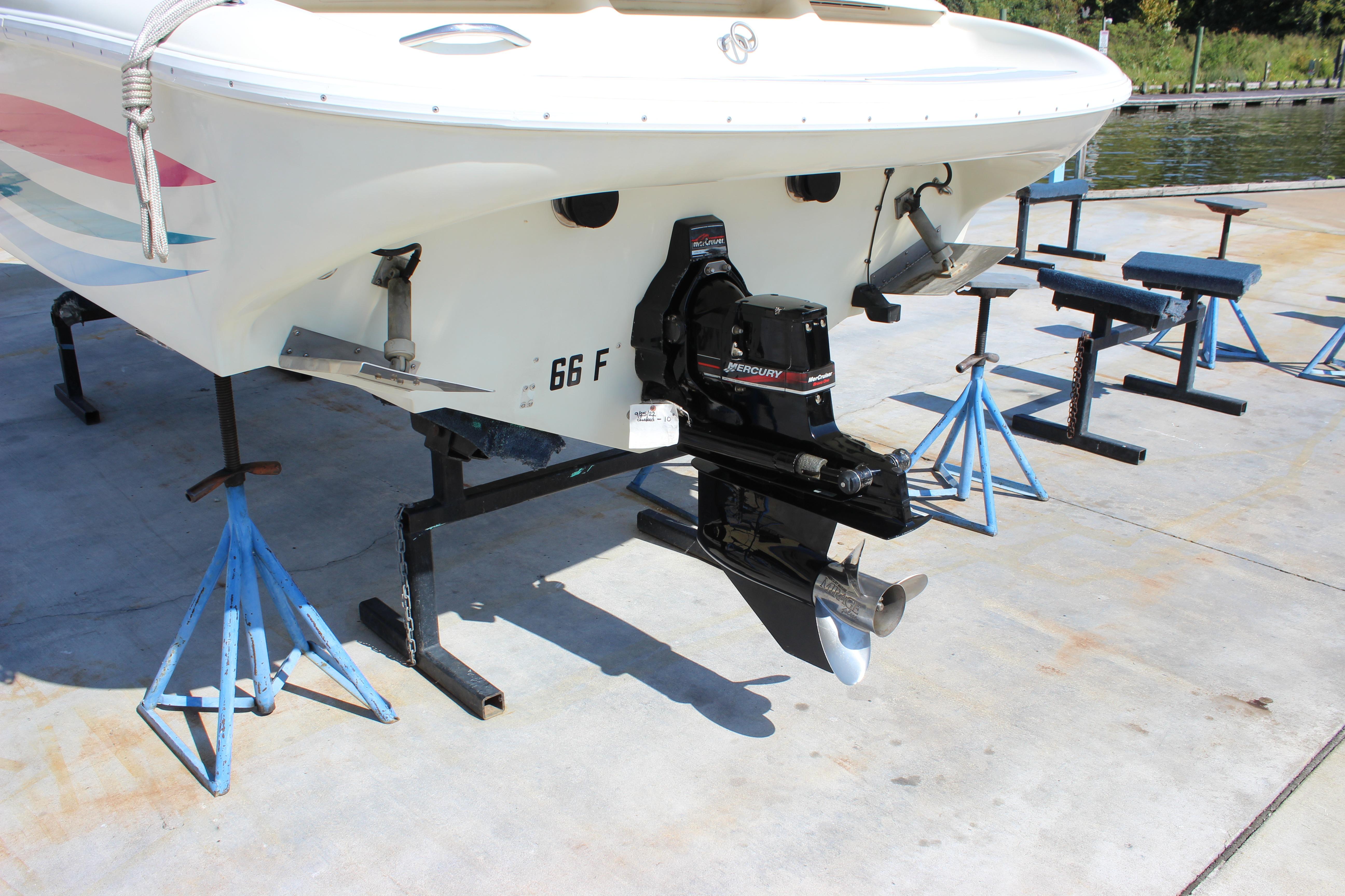 1995 Baja 272 boat on stands, featuring a Mercury outboard motor.