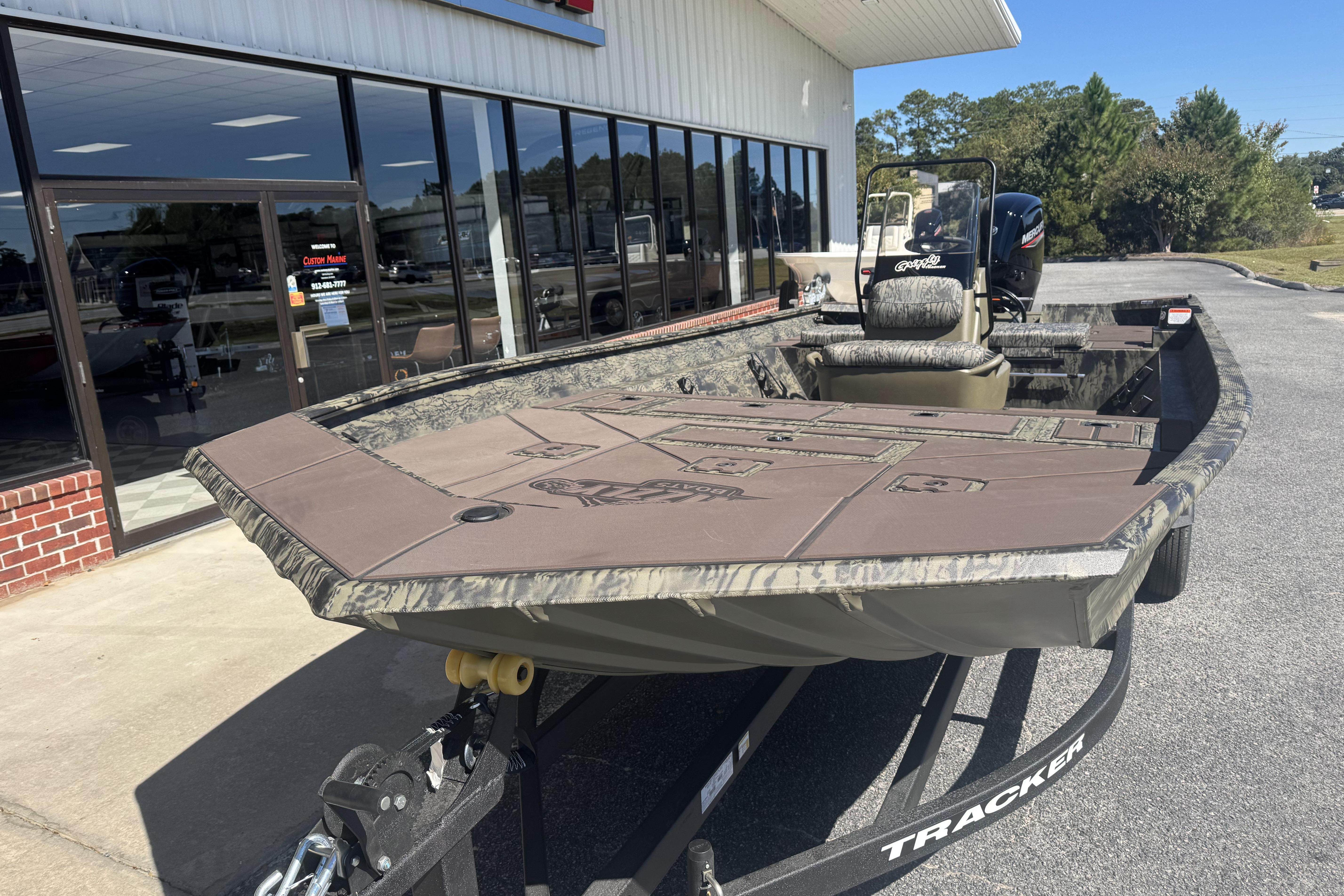 2026 Tracker Grizzly 2072 CC boat on trailer outside dealership.