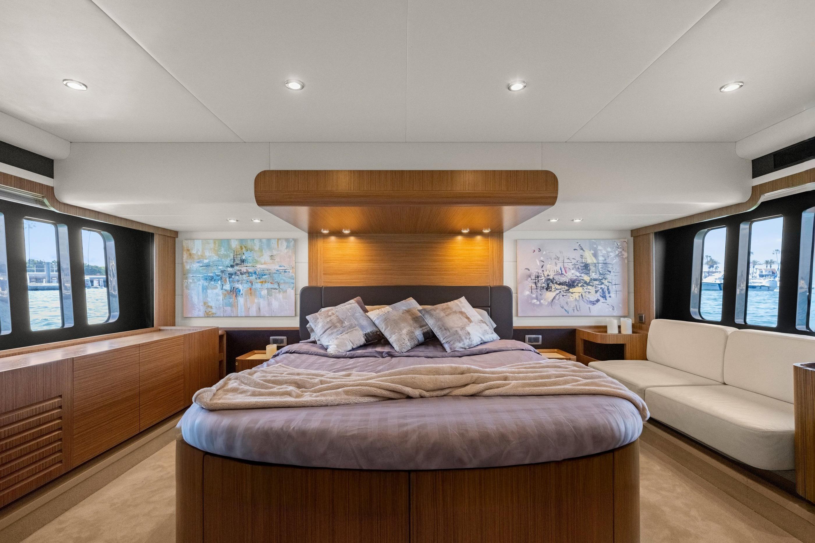 Luxurious 2018 Absolute Navetta 52 yacht bedroom with elegant decor and panoramic windows.