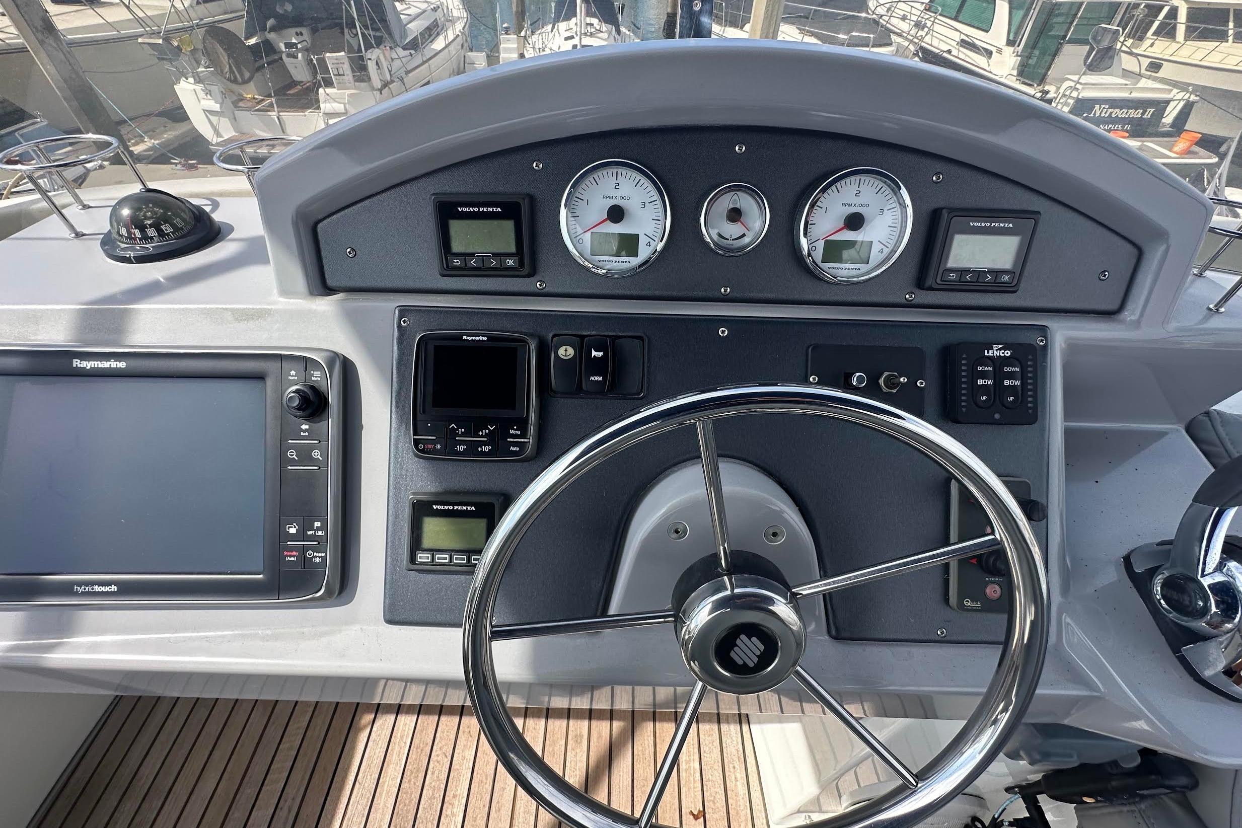 Helm of 2015 Beneteau Swift Trawler 44 with navigation instruments and steering wheel.