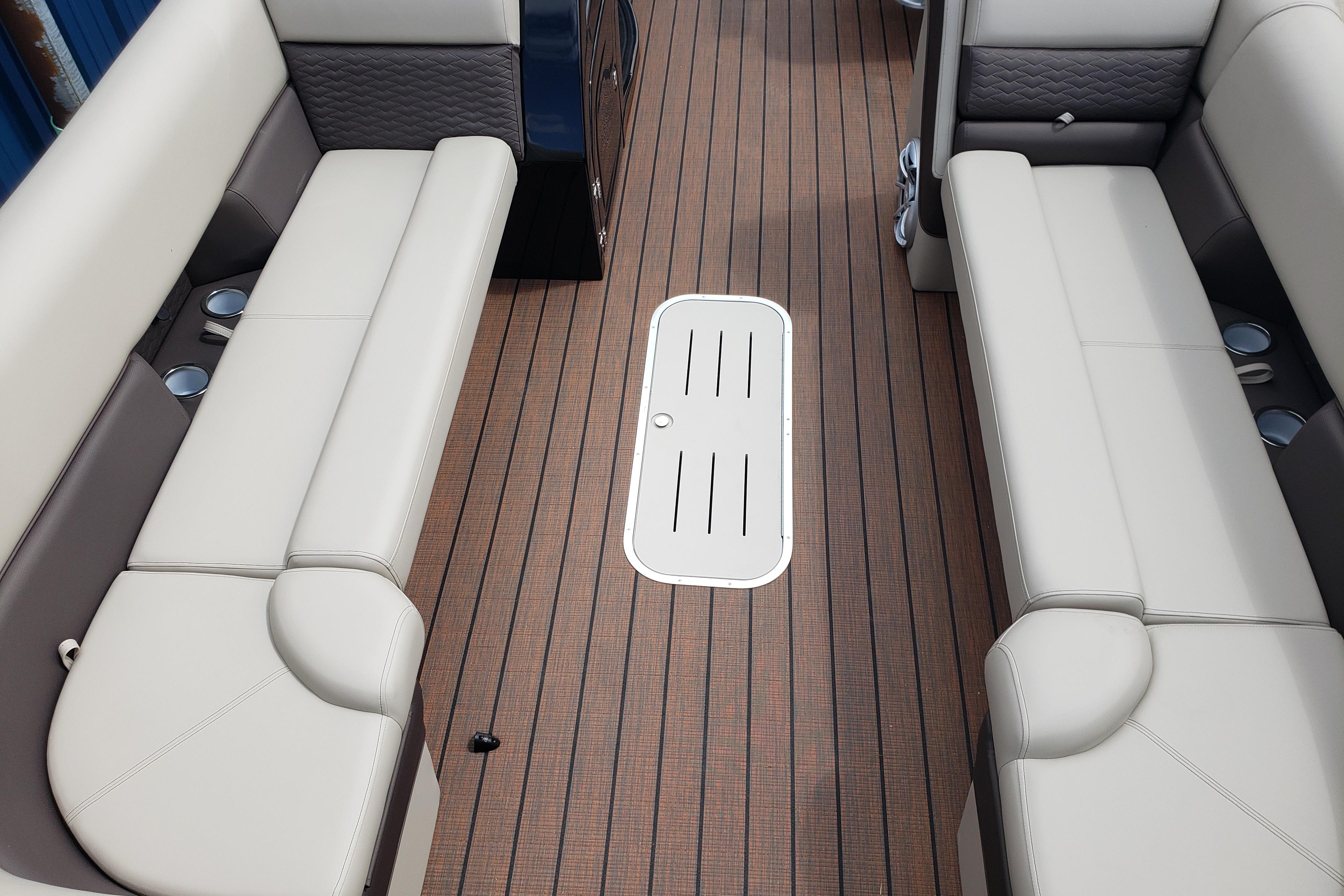 Interior of 2026 Bentley Pontoons Elite 253 QSB with beige seating and wood flooring.