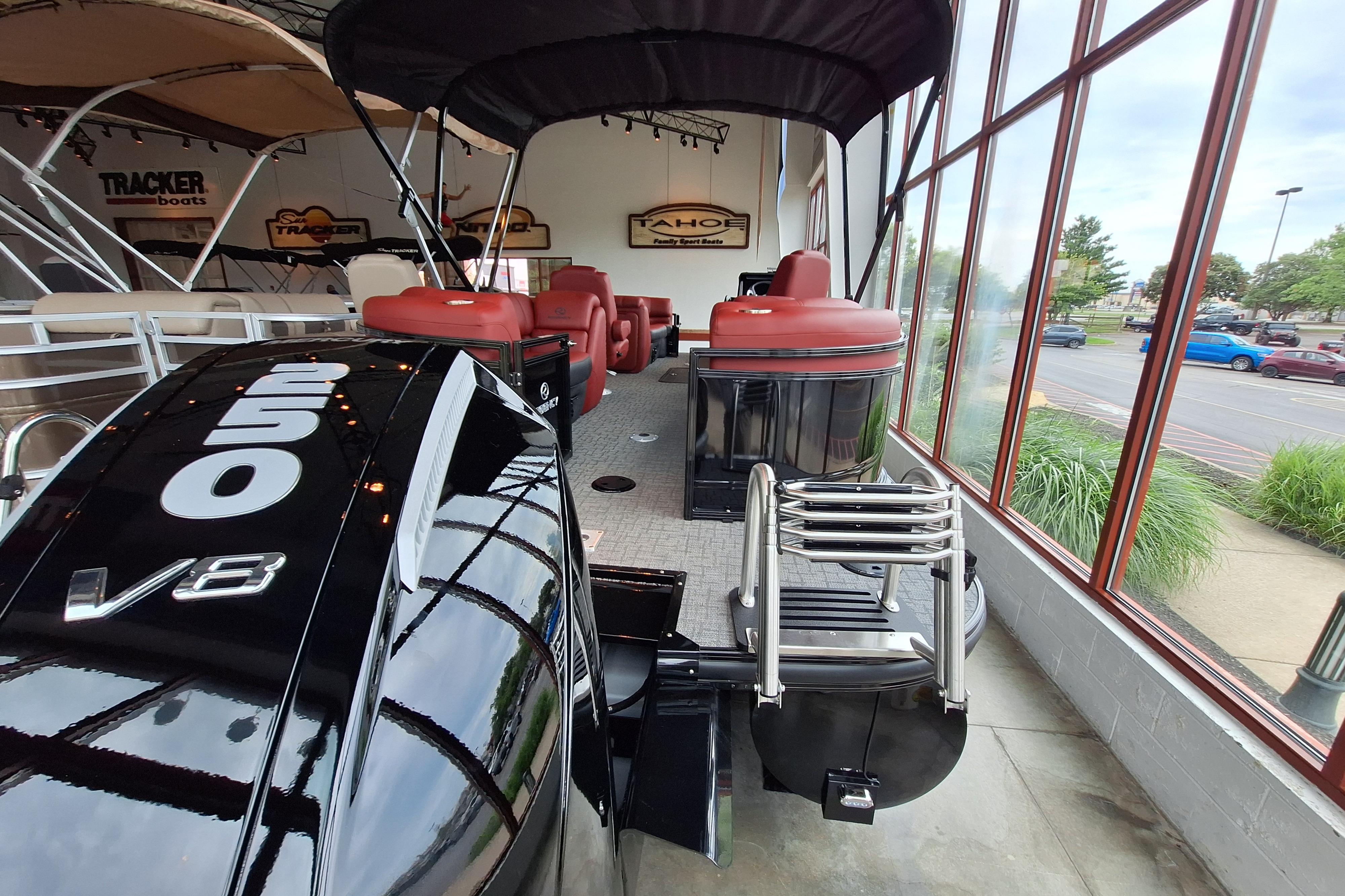 2026 Regency 230 DL pontoon boat with V8 engine, showcased indoors.